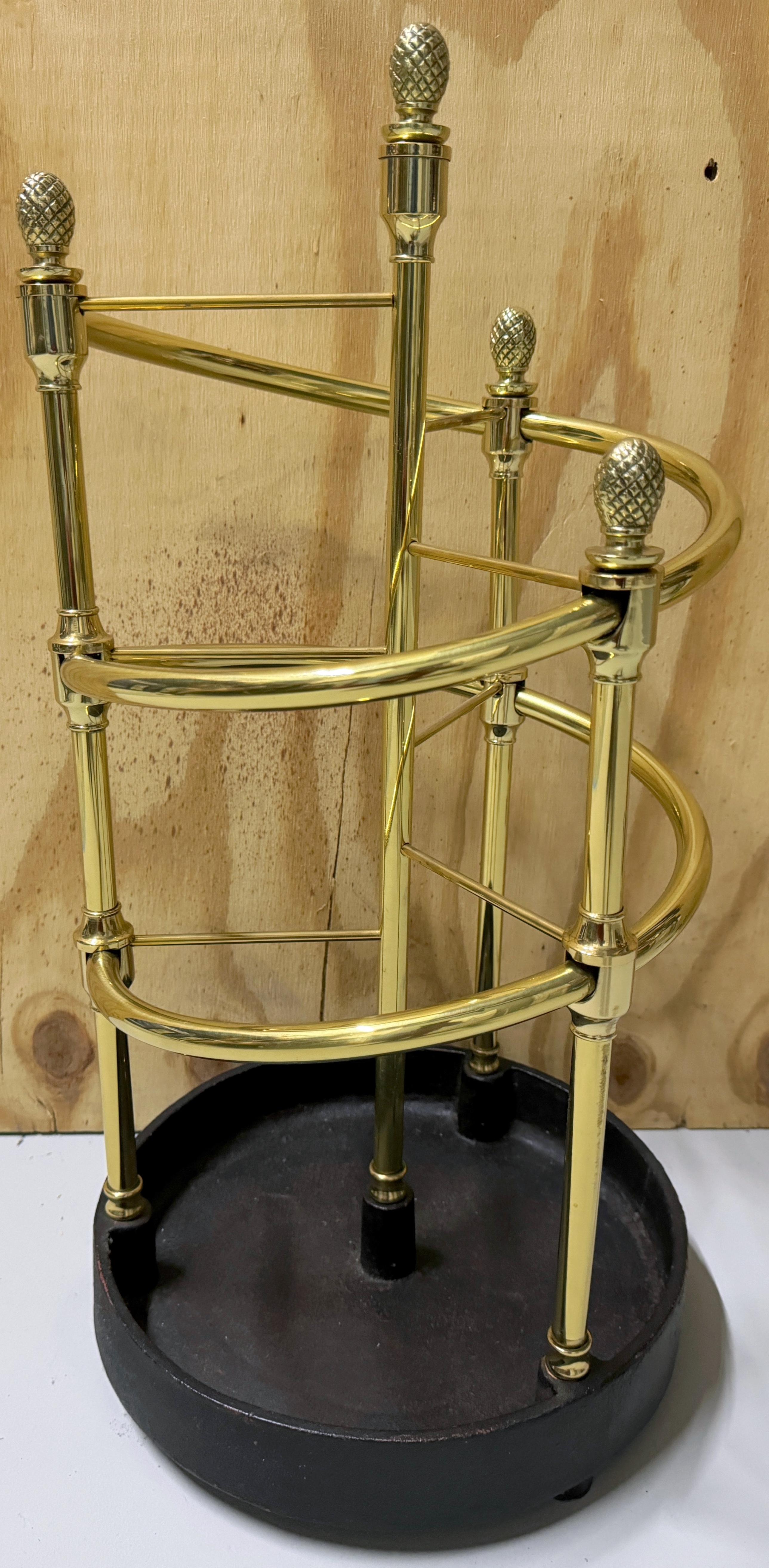 English Regency Style 'Spiral' Brass & Iron Umbrella/ Cane Stand  
England, 20th Century 

A sheik English regency style brass & iron umbrella/cane stand hailing from 20th Century England. This elegant stand stands at a height of 24 inches and