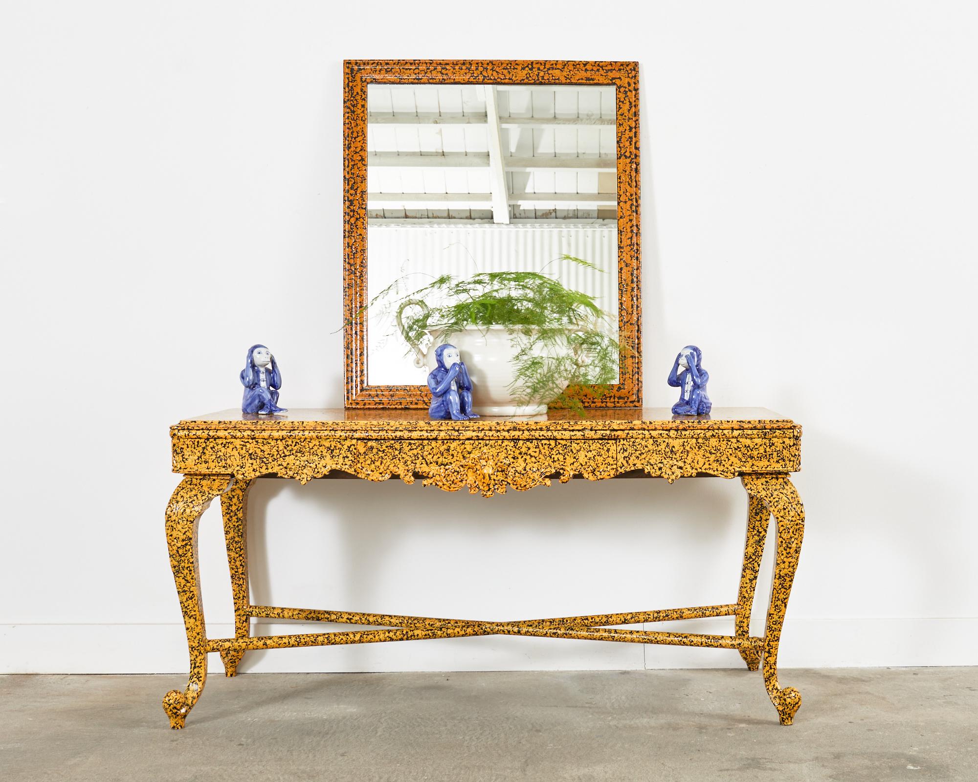 Whimsical lacquer spreckled console table painted by artist Ira Yeager (1938-2022). The console features a mustard yellow lacquer over a dramatic black background. The case is fronted by a single storage drawer decorated with acanthus scroll work.