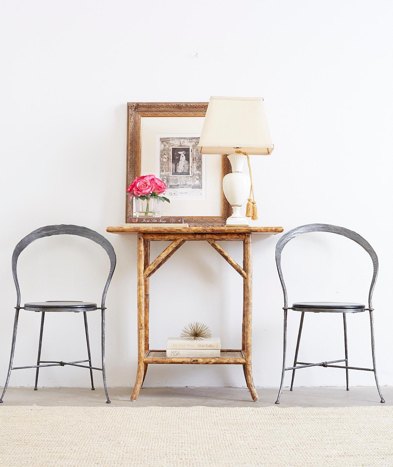 Two-tier English Regency style bamboo and raffia or grass cloth table. Features a tortoiseshell style bamboo frame with raffia covered tops. Versatile piece that could be a server, center, or side table.