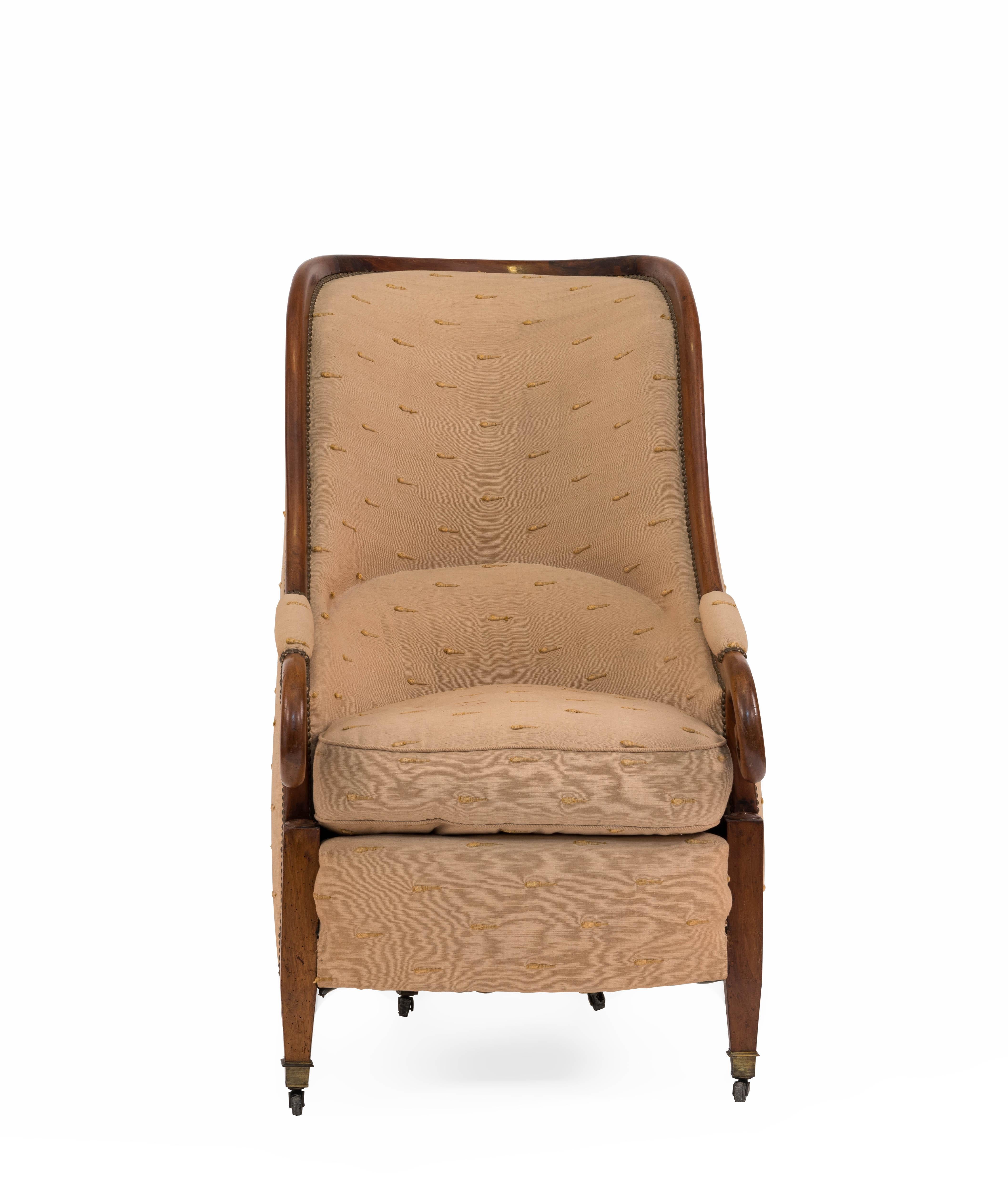 English Regency-style (19th Century) walnut club chair with scroll arms and rounded high back.

