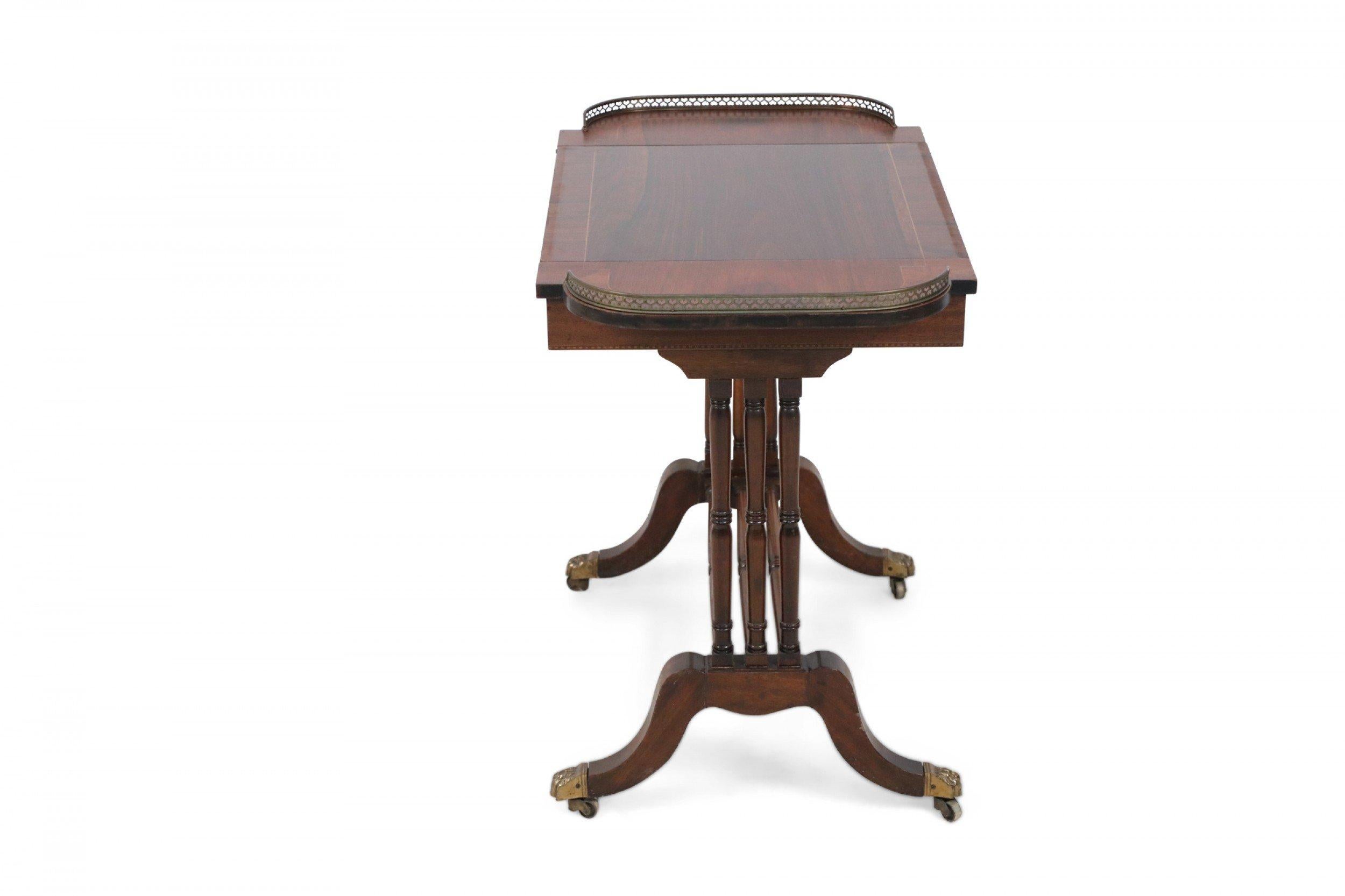 English Regency-style (19th century) mahogany game table with metal heart detailed gallery surrounding a central top panel that slides out and flips to reveal a chess/checkerboard on the underside and a leather backgammon table in the recessed