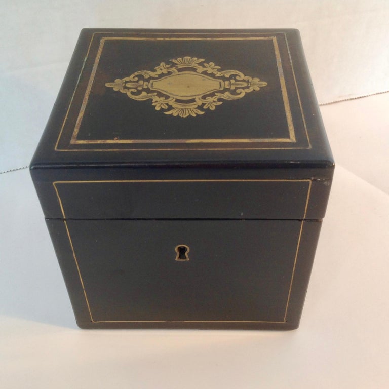 Rich mahogany with fine brass inlay and embellishments.
The caddy retains its two original interior lids.
A perfect cube form.