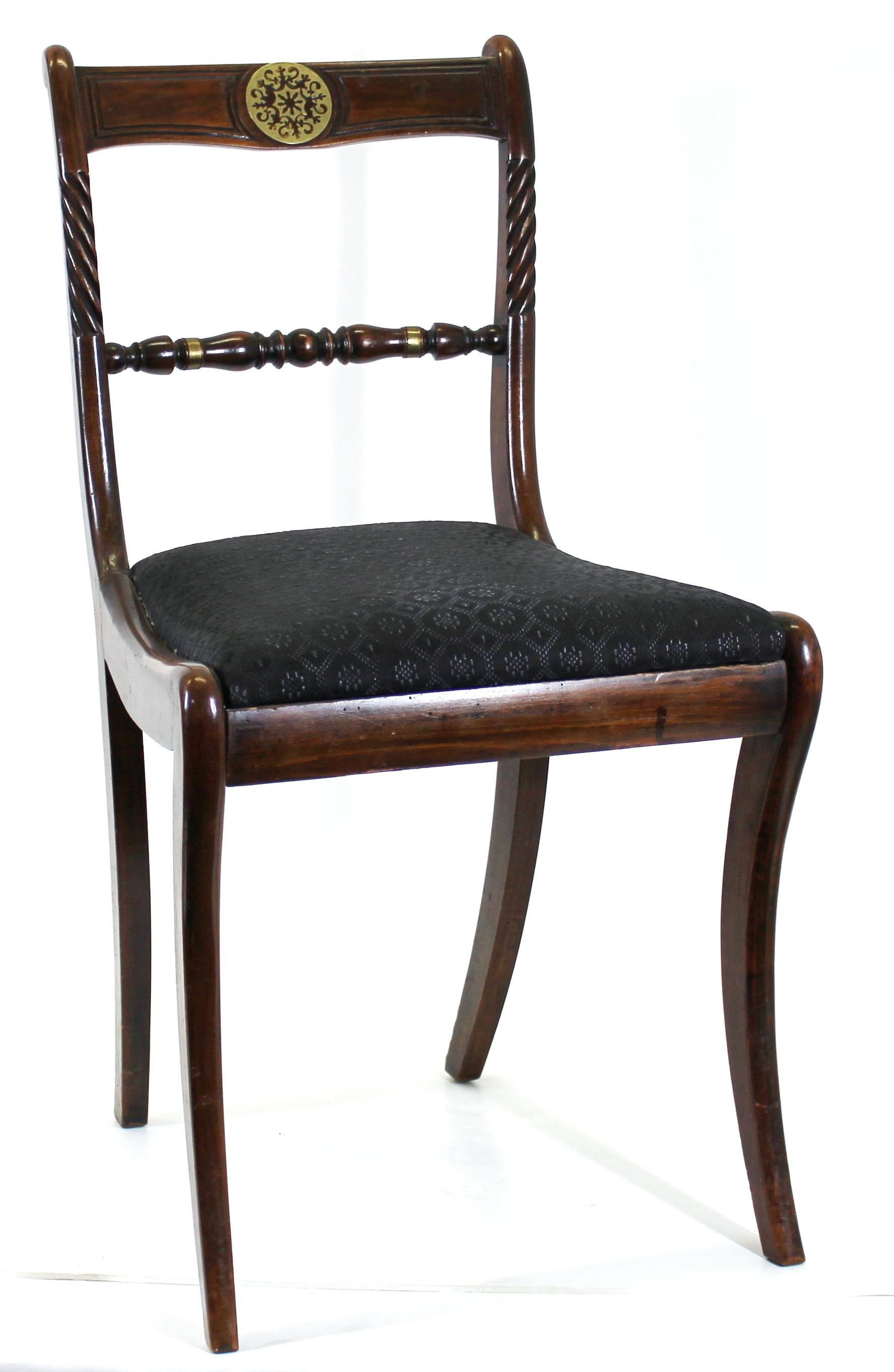 English Regency 'Trafalgar chairs' with sabre shaped legs and brass embellishments. Nautical elements like rope carved risers evoke the British Royal Navy and the Battle of Trafalgar, after which this type of chair became popular, Circa 1810. Set of