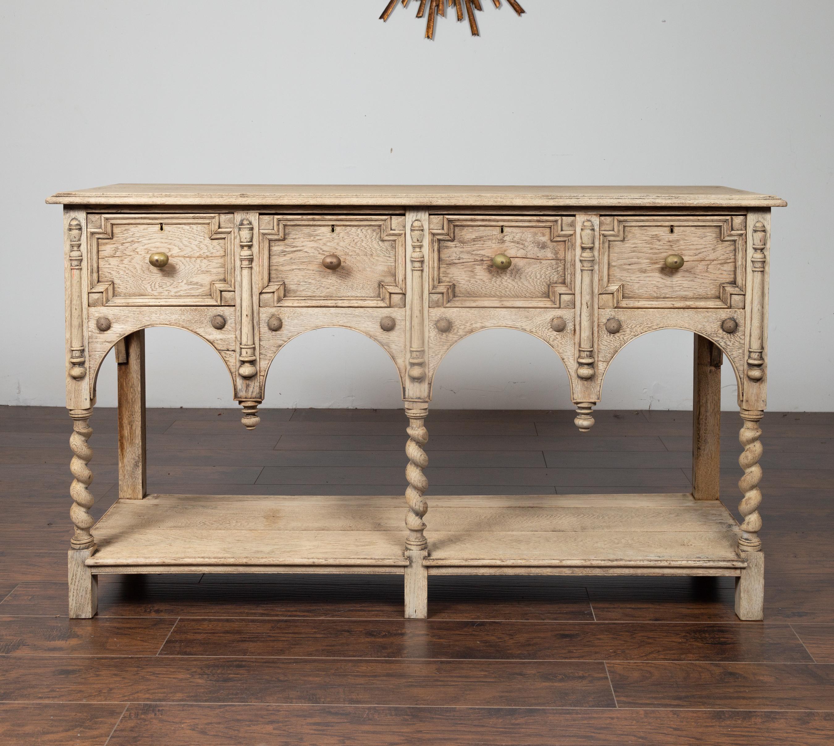 This exquisite English late 19th century bleached server features a rectangular top with beveled edge over four geometric drawers with brass pulls. The graceful Renaissance inspiration is noticeable in the facade. The server is indeed supported by