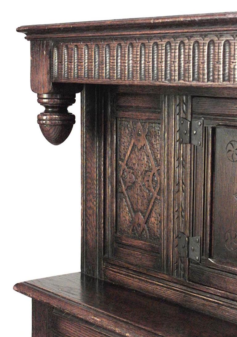 English Renaissance-style (19th Century) oak carved sideboard cabinet with 4 Wainscot paneled doors and fluted top molding.
