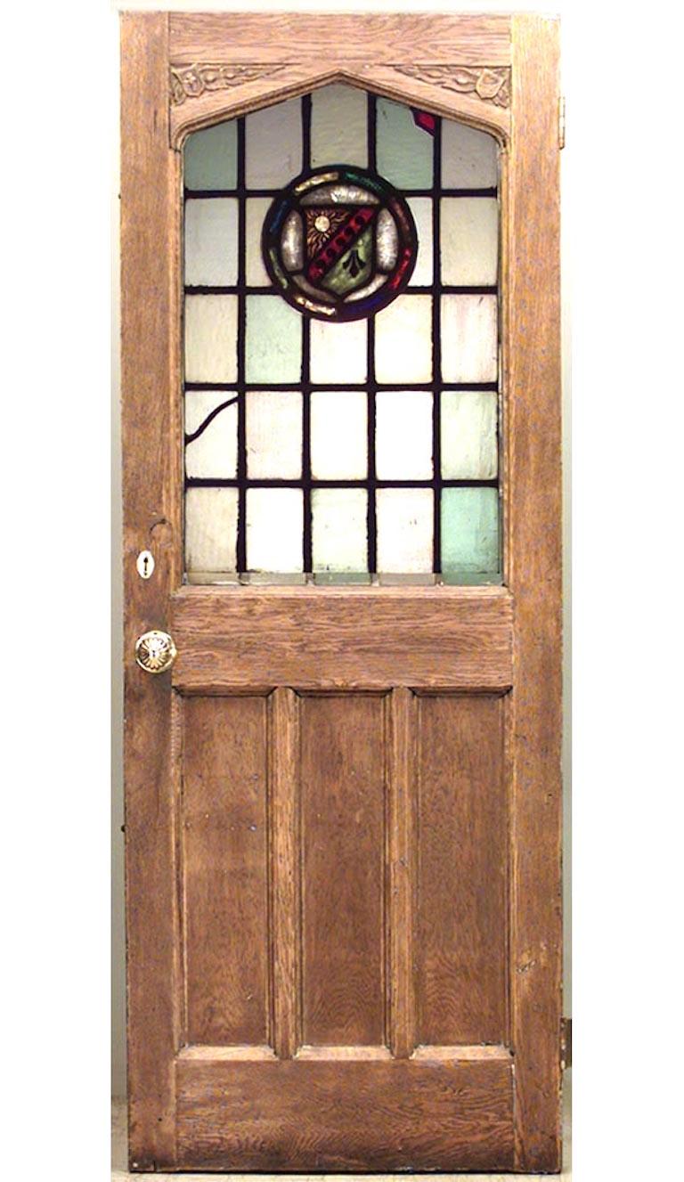 English Renaissance style (19th Century) oak framed door with arch top and leaded-glass panel with round medallion

