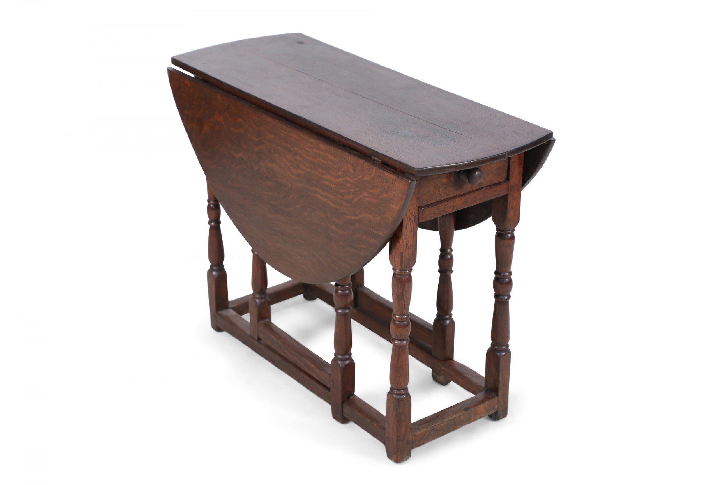 English Renaissance-style (18/19th Century) walnut serving / side table with two drop leaves supported on turned gate legs, and having a single drawer with a wooden knob.