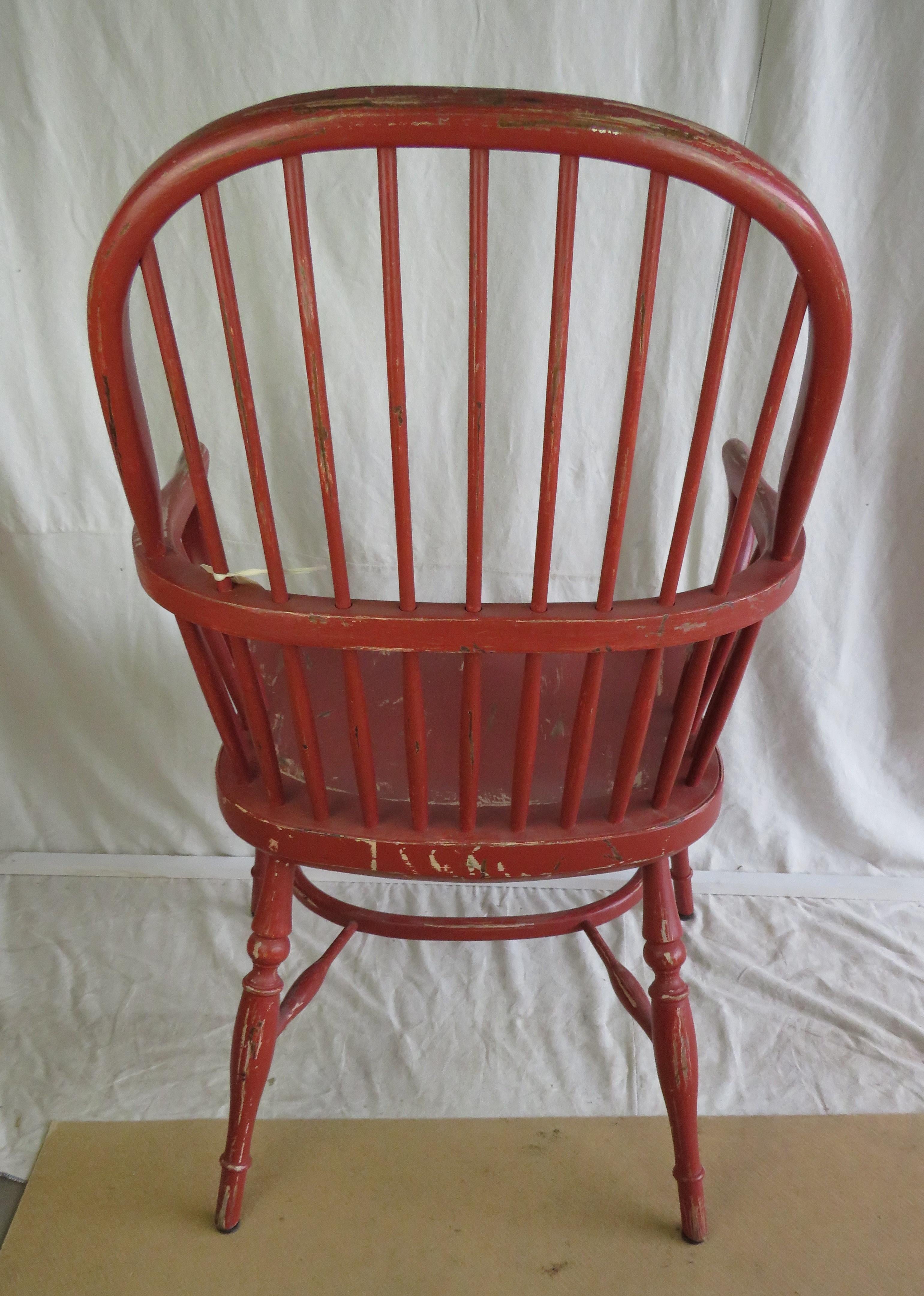 English reproduction of a stick back armchair in distressed red paint finish.