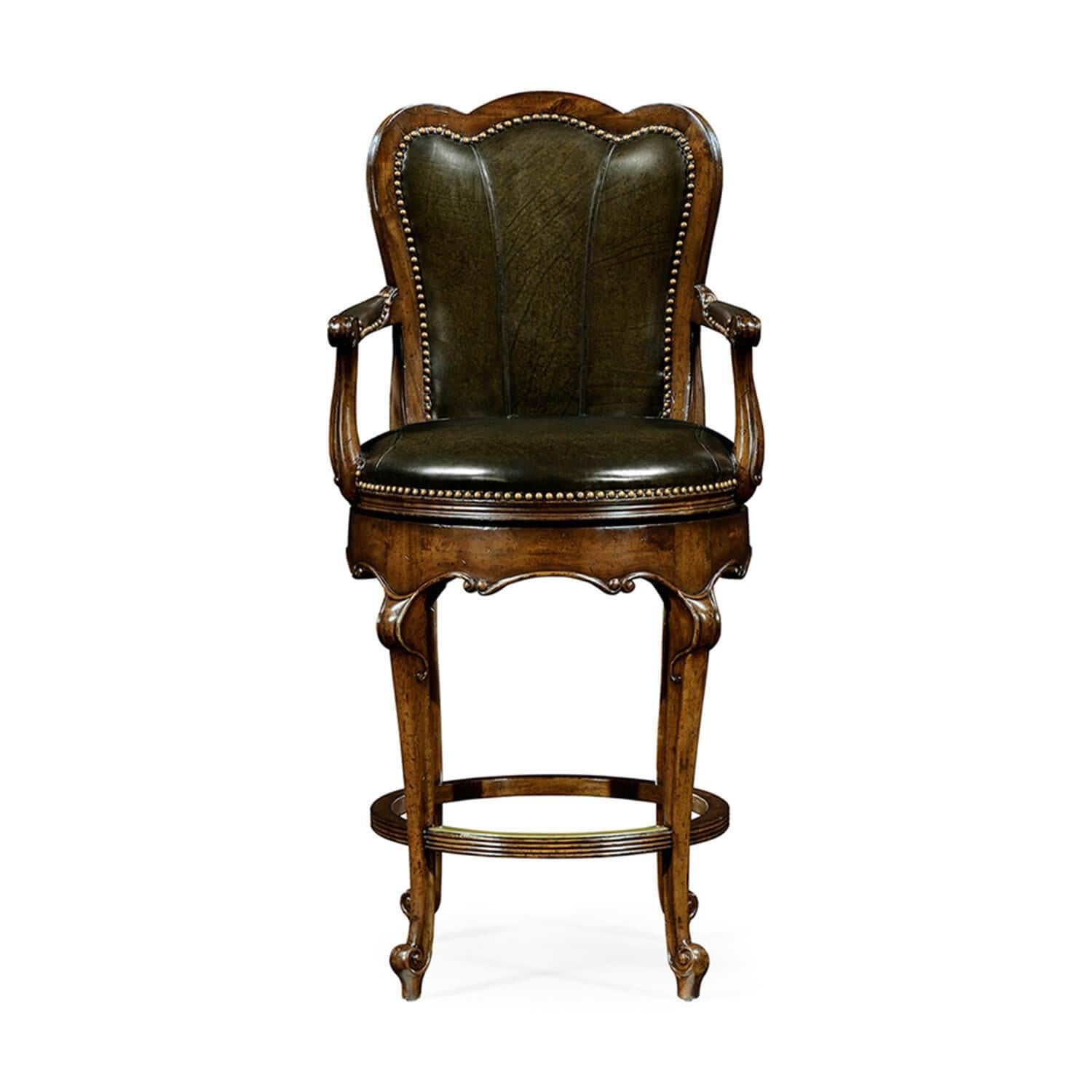 Upholstered bar stool with arms in studded dark green leather set within a walnut frame, padded arm caps, and a revolving mechanism set above four cabriole legs and an undulating rail.

Dimensions: 22 7/8