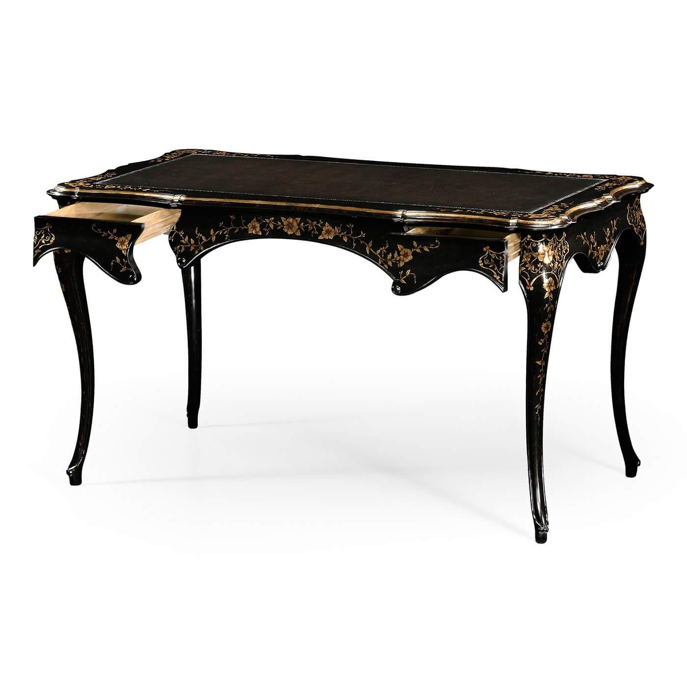 Elegant English Rococo black painted desk with antiqued dark leather inlaid writing surface and a profusion of hand painted gilt floral detail on apron and legs. 

Dimensions: 54