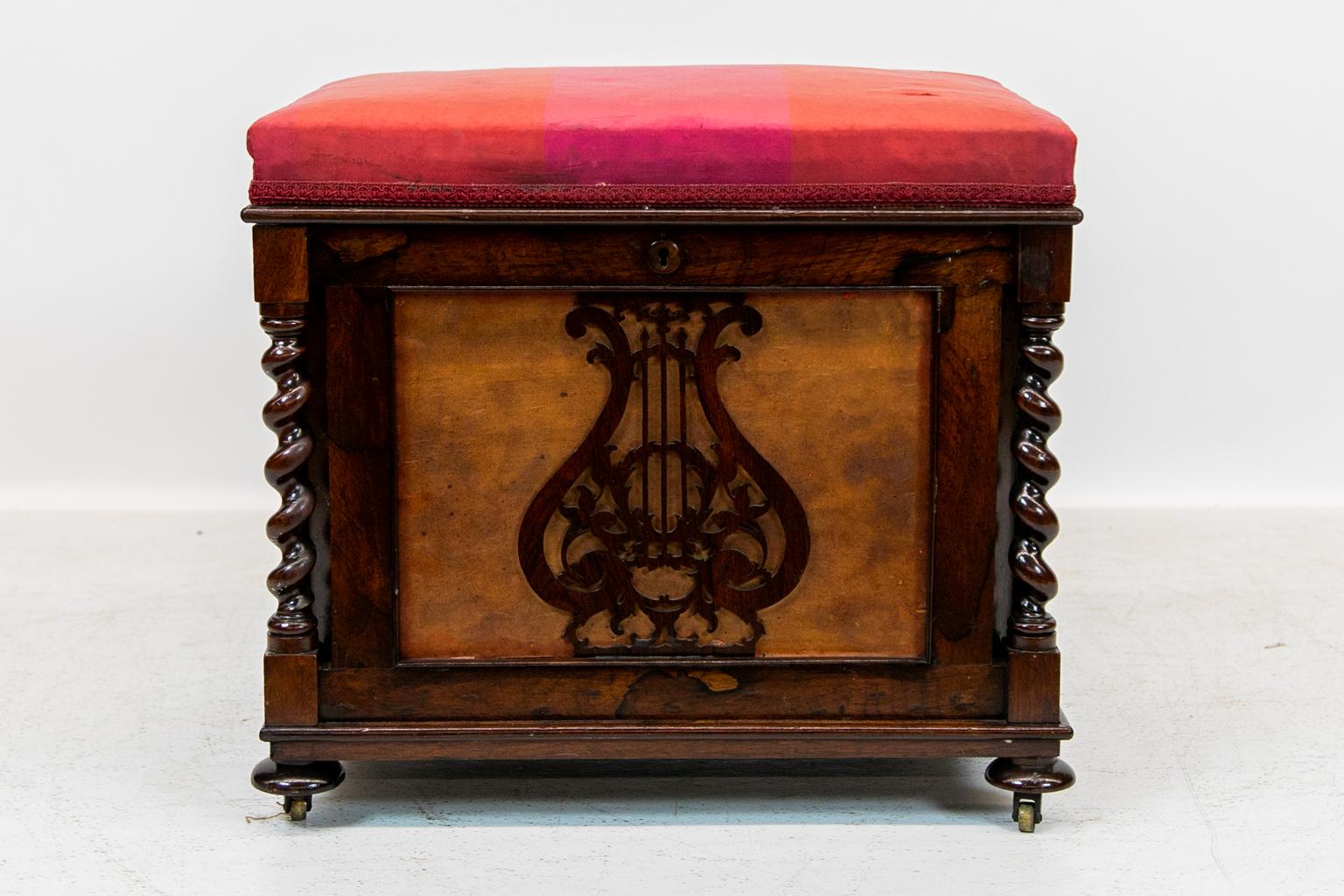 English Rosewood bench, has a carved reticulated lyre on the front and a reticulated carved arabesque on the sides. There are carved barley twist columns on the corners terminating in mushroom feet. The fabric is consistent with wear and age.
 