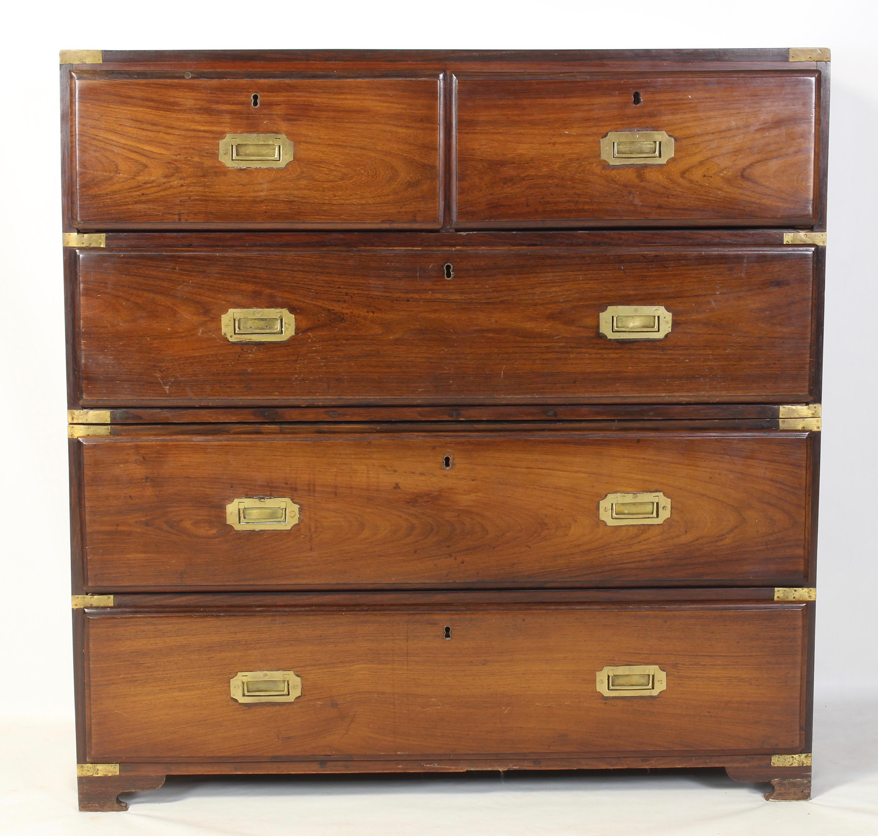 A handsome two-piece mid-19th century. English brass bound rosewood campaign chest of drawers with inset brass handles resting on low bracket feet.