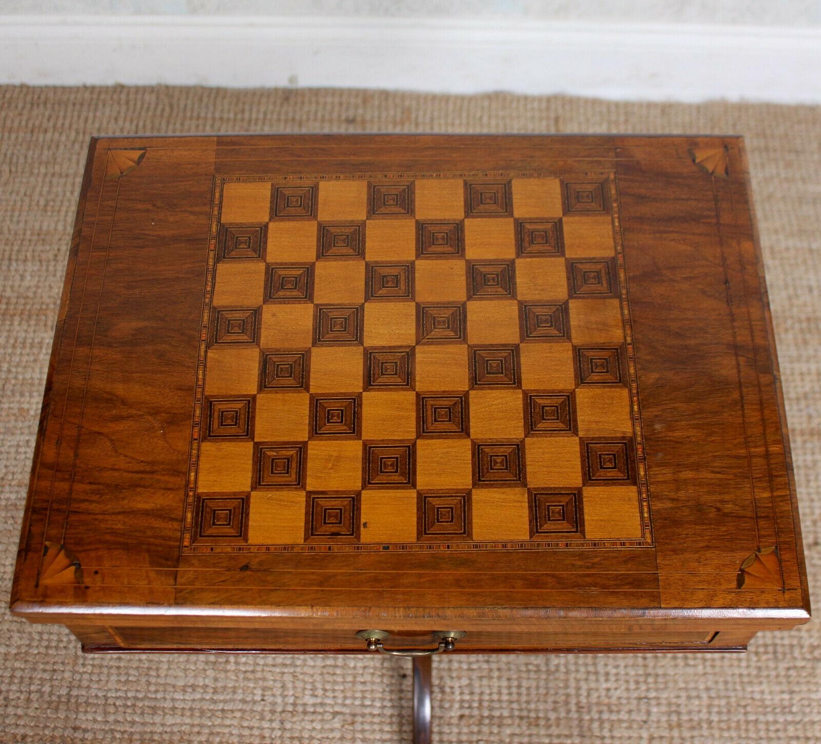 An elegant fine quality 19th century inlaid rosewood games table.

The hinged rectangular top with inlaid checkerboard enclosed a baize lined playing surface and Tunbridgeware cribbage board. Fitted a single frieze drawer with fitted interior and