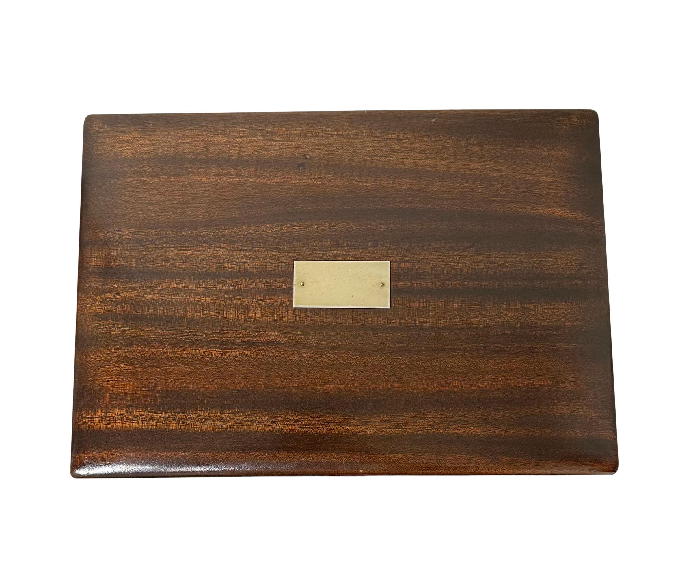 A 1920s English Rosewood humidor. The interior is white and the plaque does not have a monogram.