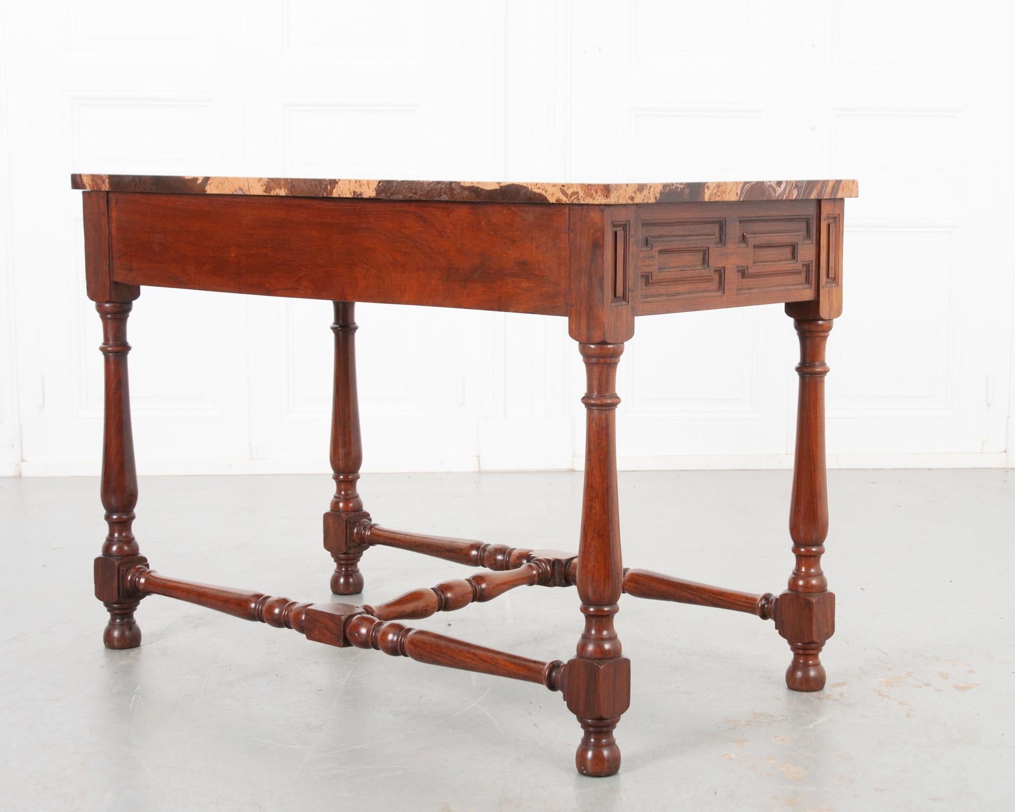 An absolutely stunning center table for any space! The gorgeous new marble top perfectly compliments the warm toned rosewood base. Quality craftsmanship is evident in the artfully carved geometric panels on each end of the table and beautiful turned