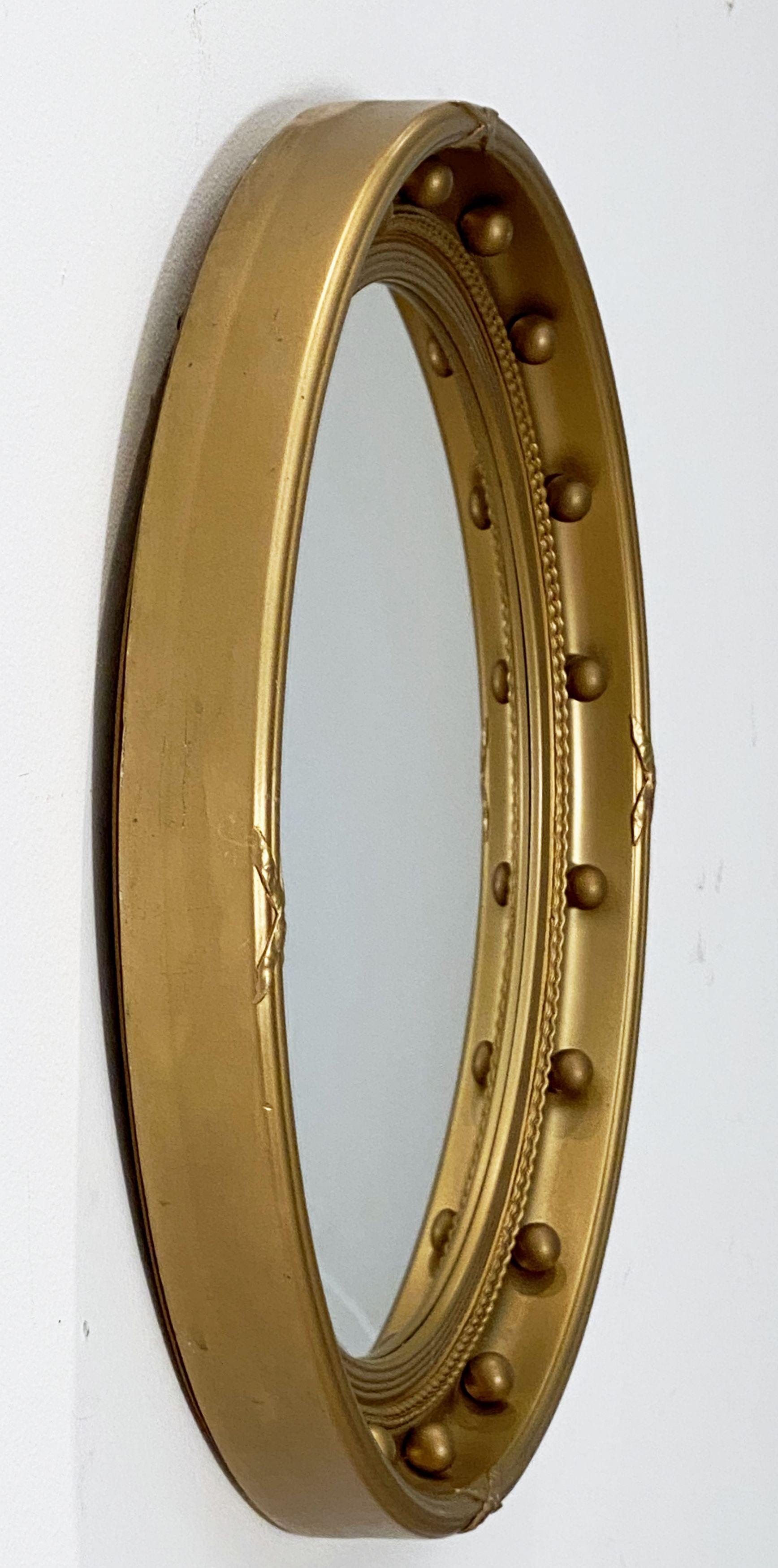 A fine English round or circular convex mirror featuring a Regency design of a moulded gilt frame, with gilt balls around the circumference.

Dimensions: Diameter 20 1/2 inches x Depth 2 1/4 inches