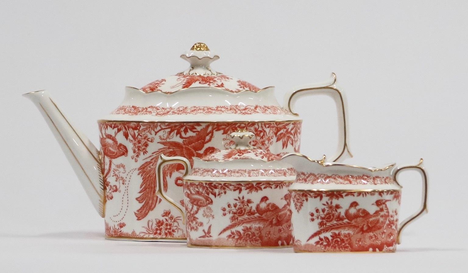 English bone china tea set of three pieces by Royal Crown Derby, “Red Aves” design, with tea pot, sugar bowl with lid and creamer. Never used and in excellent vintage condition.
Measures: Tea pot: 11.5 in (29 cm) W. x 5.5 in (14 cm) D. x 7 in ( 18