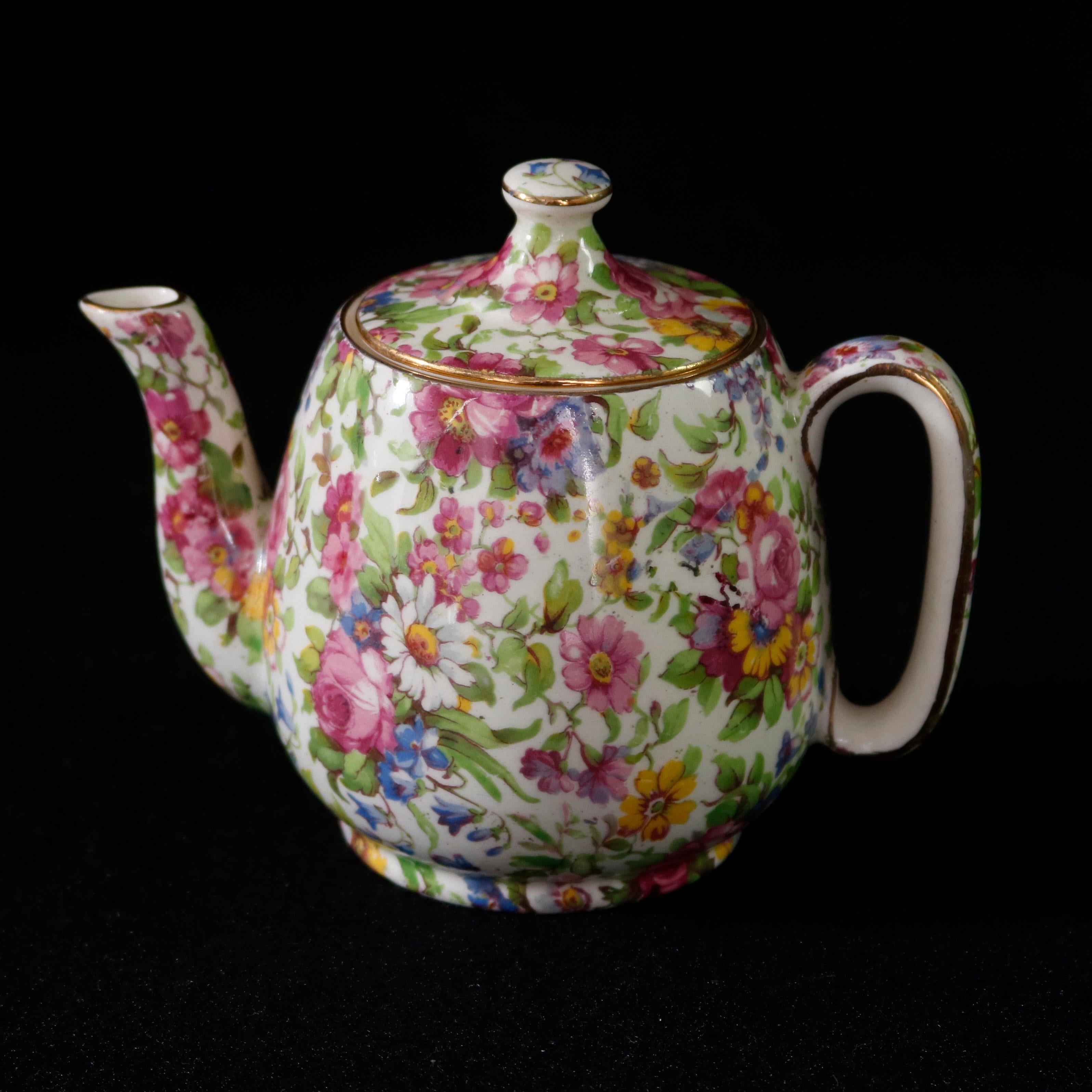 An antique English porcelain tea set by Royal Winton Grimwaders in Summertime pattern offers all-over floral chintz pattern, circa 1920

Measures - teapot: 6