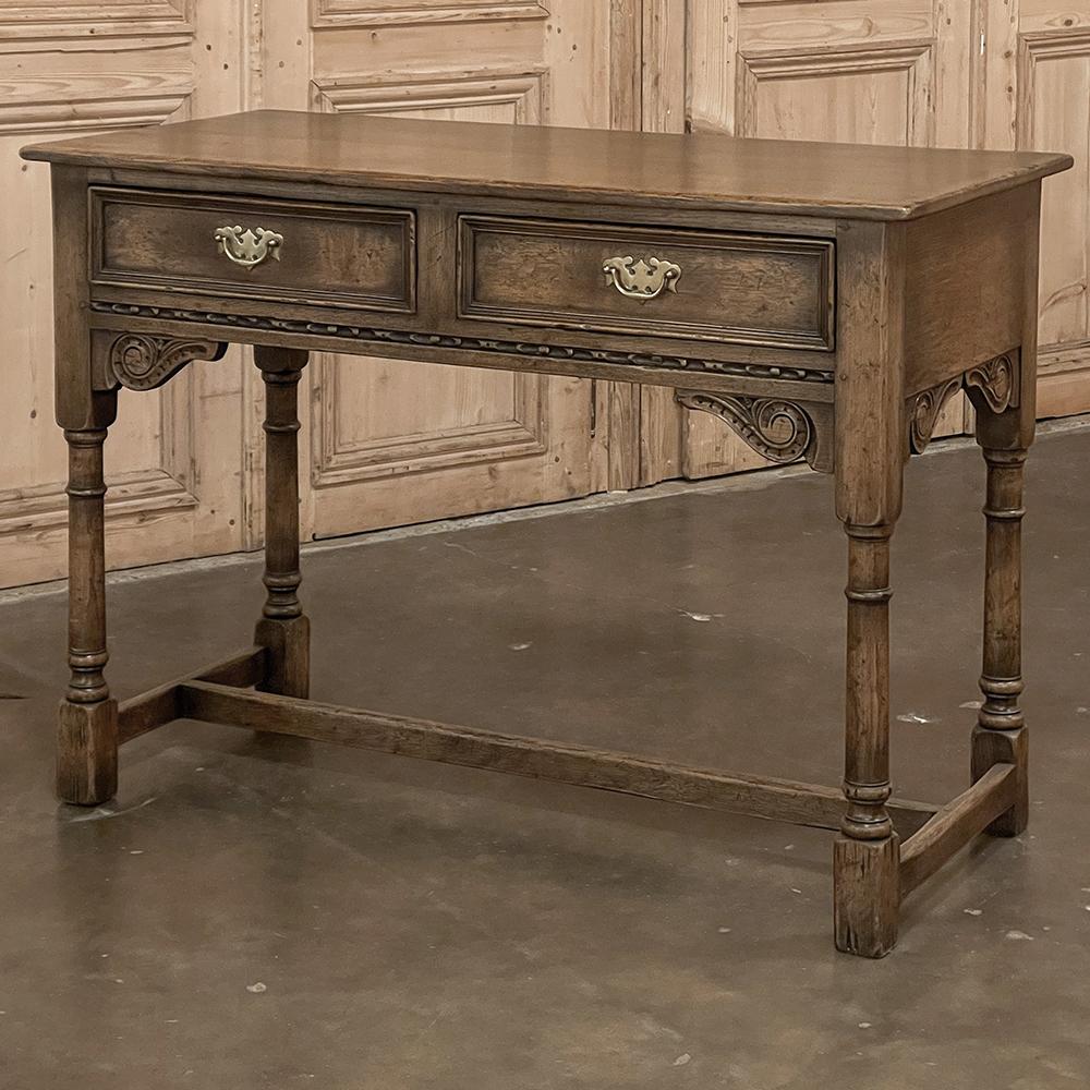 English rustic antique side table was hand-crafted using fine oak with burl elm veneer on the drawer faces and a rich, natural color that has achieved a lovely patina over the decades. The solid plank top will ensure decades of enjoyment, while the