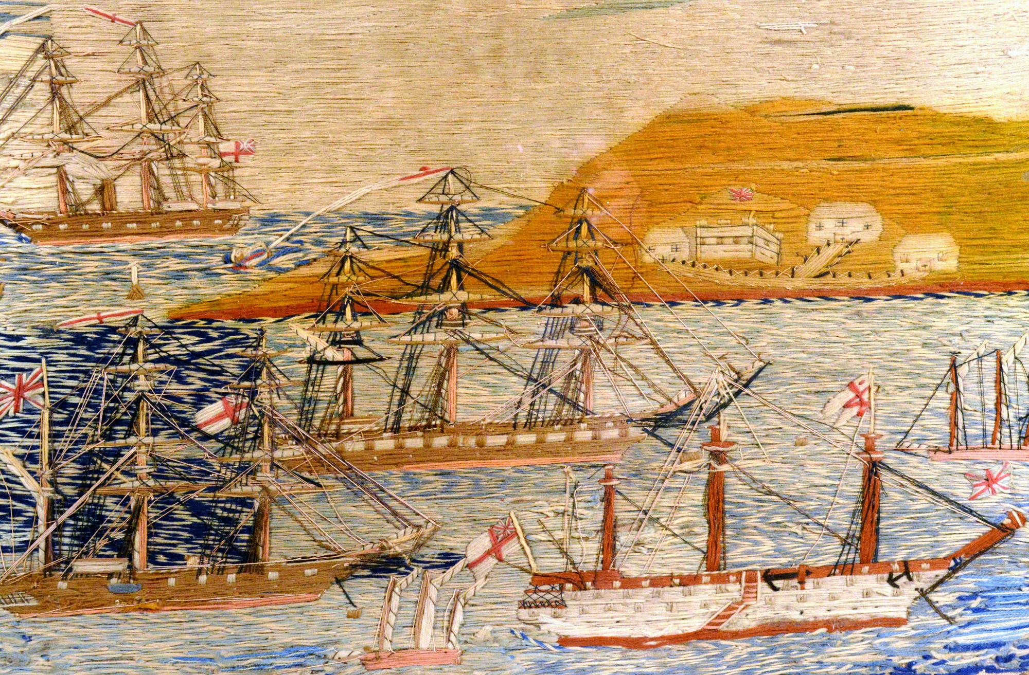 English sailor's woolwork or woolie with multiple ships in a bay, 
circa 1875.

The sailor's woolwork (Woolie) with good color and detail depicts five ships in a bay, some anchored and some sailing. Further out to sea is a large ship rounding a