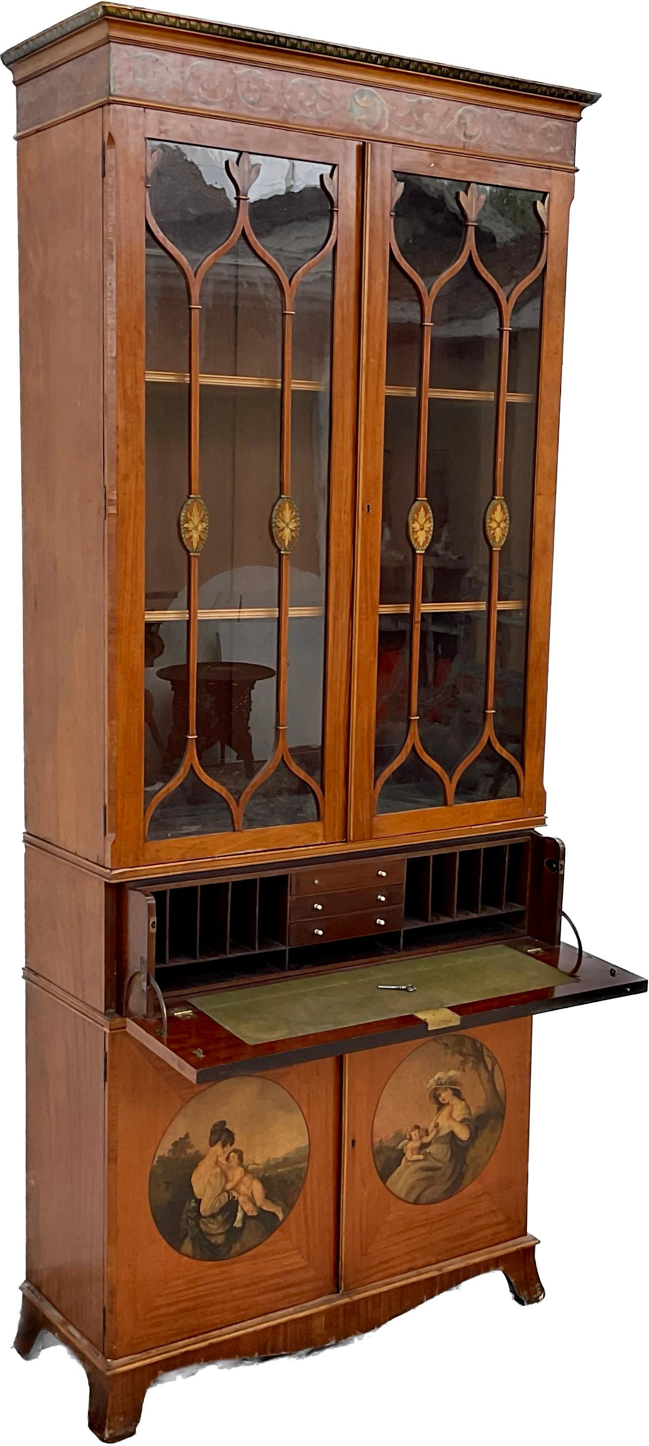 19th Century English Satinwood secretary/bookcase. Two astragal glazed doors above open to reveal two adjustable shelves for display, a fall front opening to reveal a fully fitted interior, over two further cabinet doors with hand painted portraits.