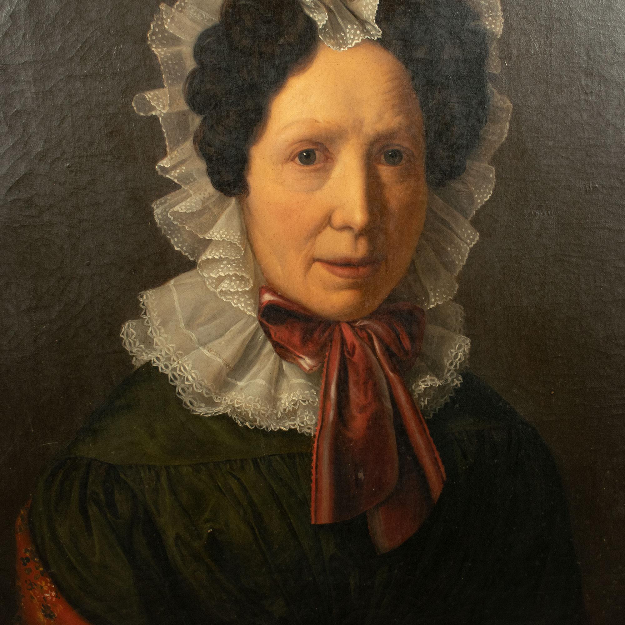 English School (early 19th Century) Portrait of a Lady, Oil on Canvas, circa 1820.

Portrait of a lady in a lace bonnet tied with red ribbons, wearing a green dress with a floral stole in matching red tones.

The painting is mounted in its original