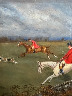 English Fox hunting scene with huntsman and hounds chasing a fox in a landscape