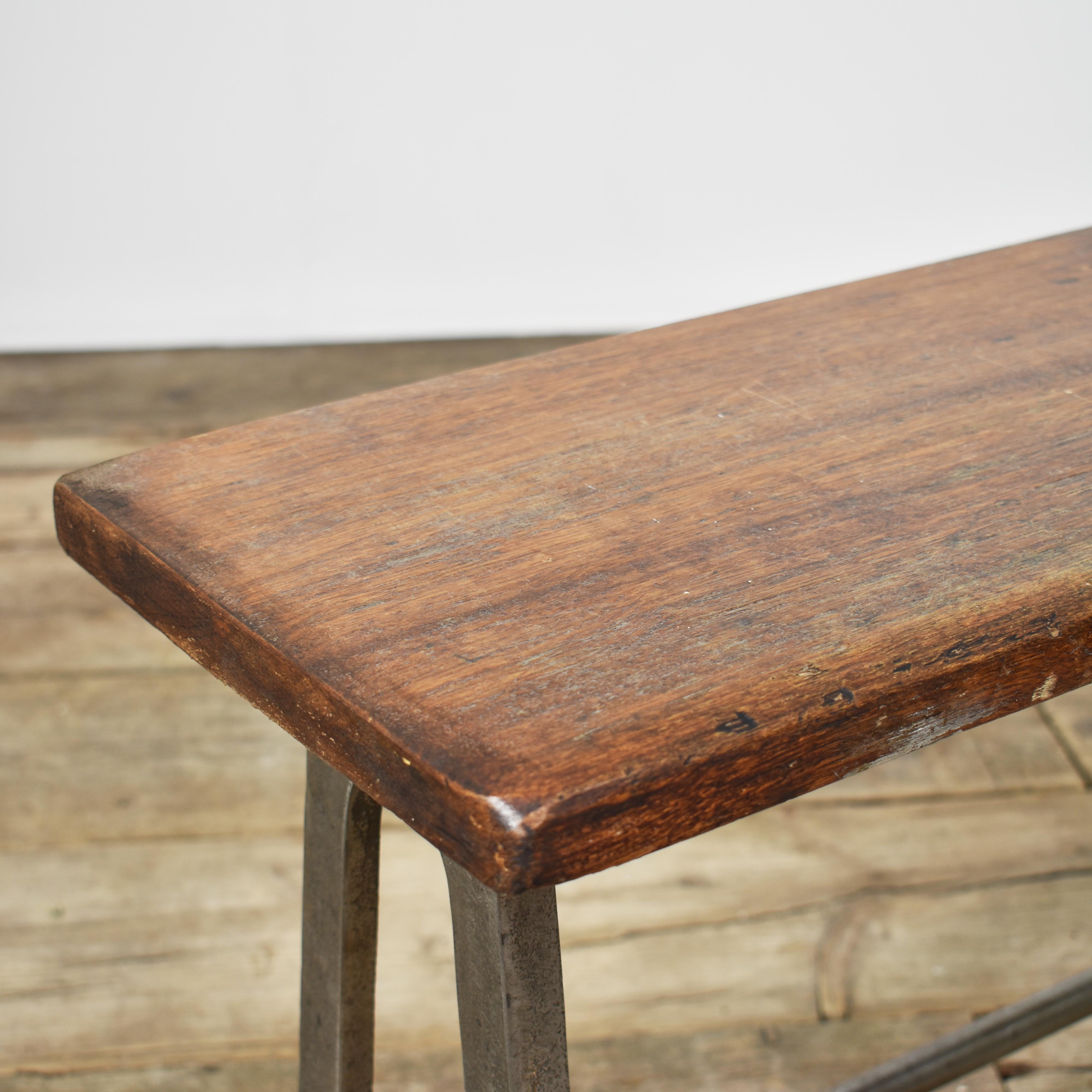 Small School Vintage Locker Room Storage Bench

A vintage School Locker Room Bench, with a lovely original hardwood wooden top salvaged from a Grammar school. The bench has cast metal legs and a pair of metal stretcher rods serving as a lower