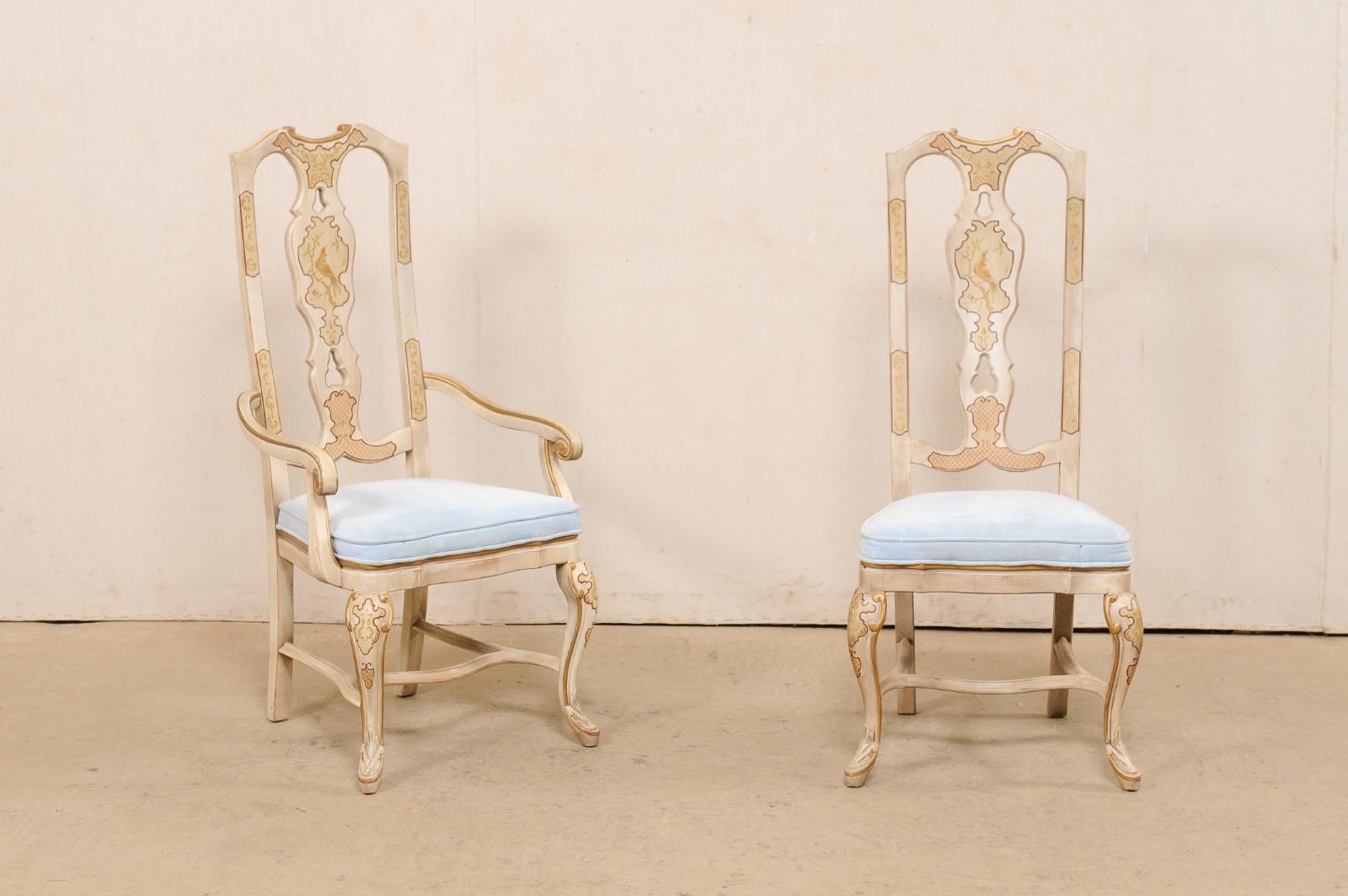 An English set of six dining chairs, with soft colors and chinoiserie style painted influences. This vintage set of chairs, comprised of a pair of armchairs and four side chairs, have tall and a nicely carved pierced splats, upholstered seats, and