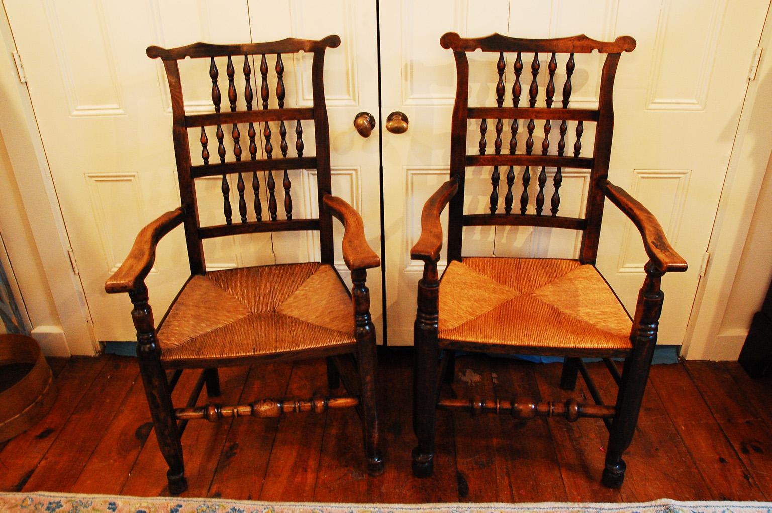 English early 19th century assembled set of eight spindleback elm and ash dining chairs including two armchairs and six sidechairs. These chairs were made in the Lancashire/Cheshire region of England and typically were purchased over a period of
