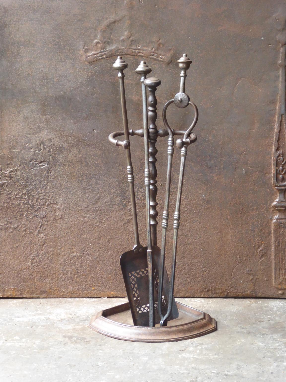 English set of three fireplace tools and a stand, made of wrought iron. The fire tool set is in a good condition and is fully functional. 19th century, Victorian.