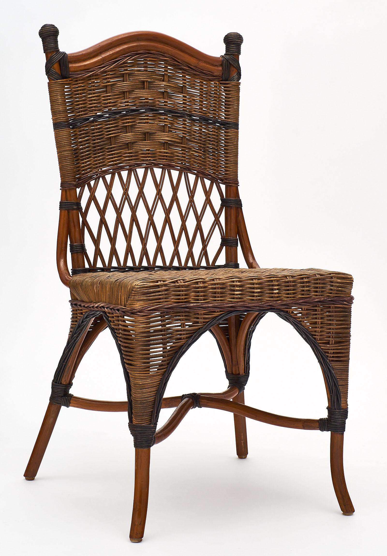 English wicker set of chairs and table in two-toned wicker. This set is in perfect condition and very comfortable. We love the strong design and details.

The measurements listed are for the chairs. The table is 29.375” in height, 22” in width,