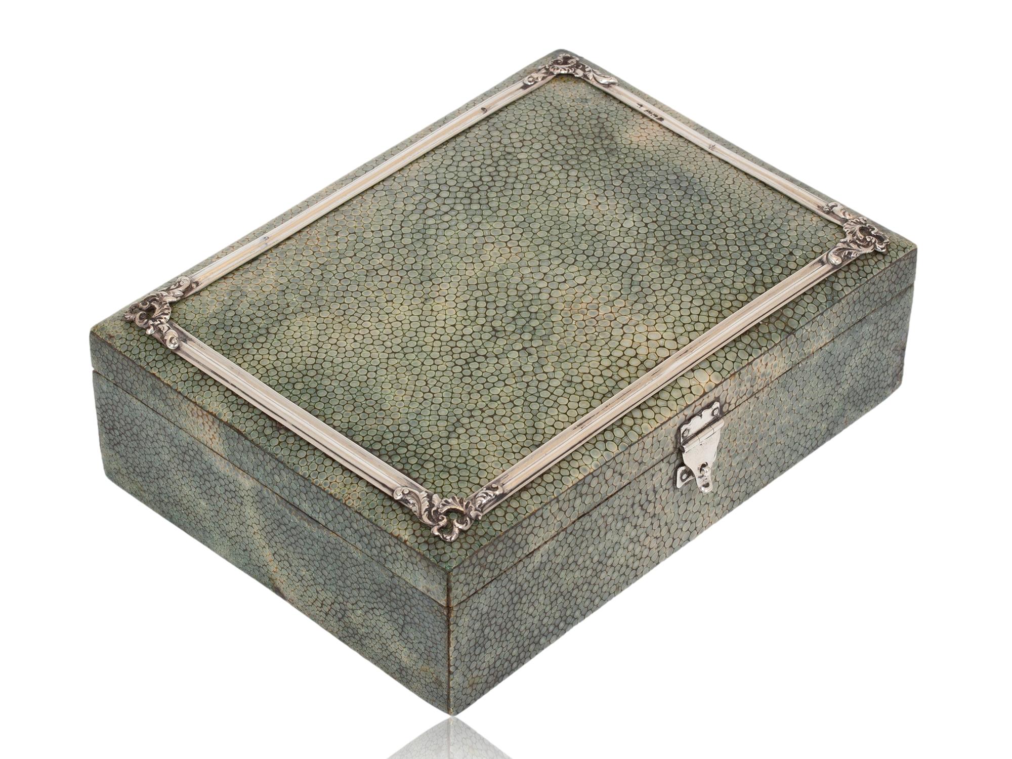 FREE WORLDWIDE SHIPPING 

Sterling Silver Mounts Dated 1908

From our Games Boxes collection, we are pleased to offer this good quality silver mounted shagreen card box. The card box of slim rectangular form veneered in striking shagreen to the