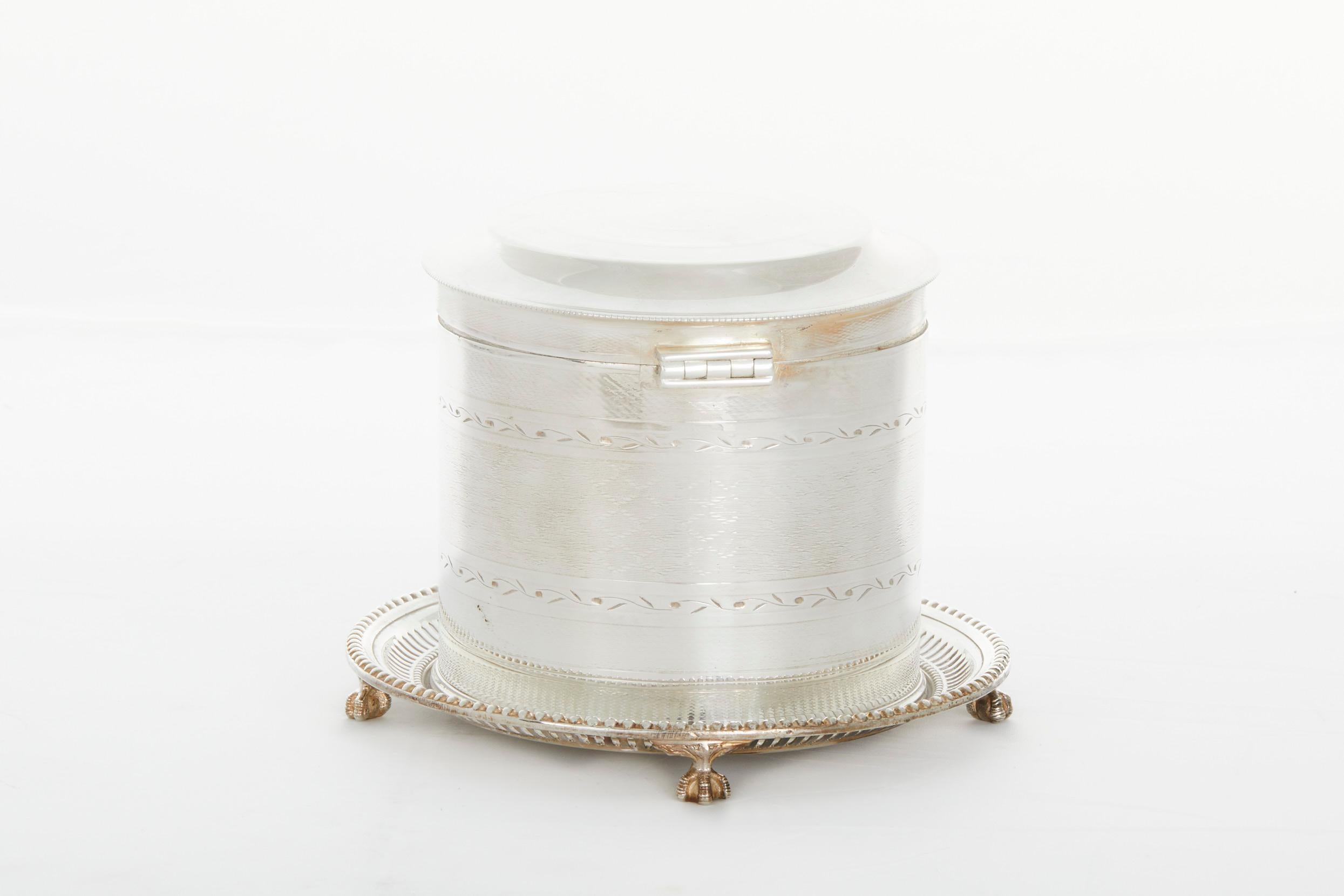 19th century English sheffield silver plate footed tea caddy / thin biscuit with exterior design details and attached covered top. The tea caddy is in good condition. Minor wear consistent with age / use. Maker's mark undersigned. The caddy stands