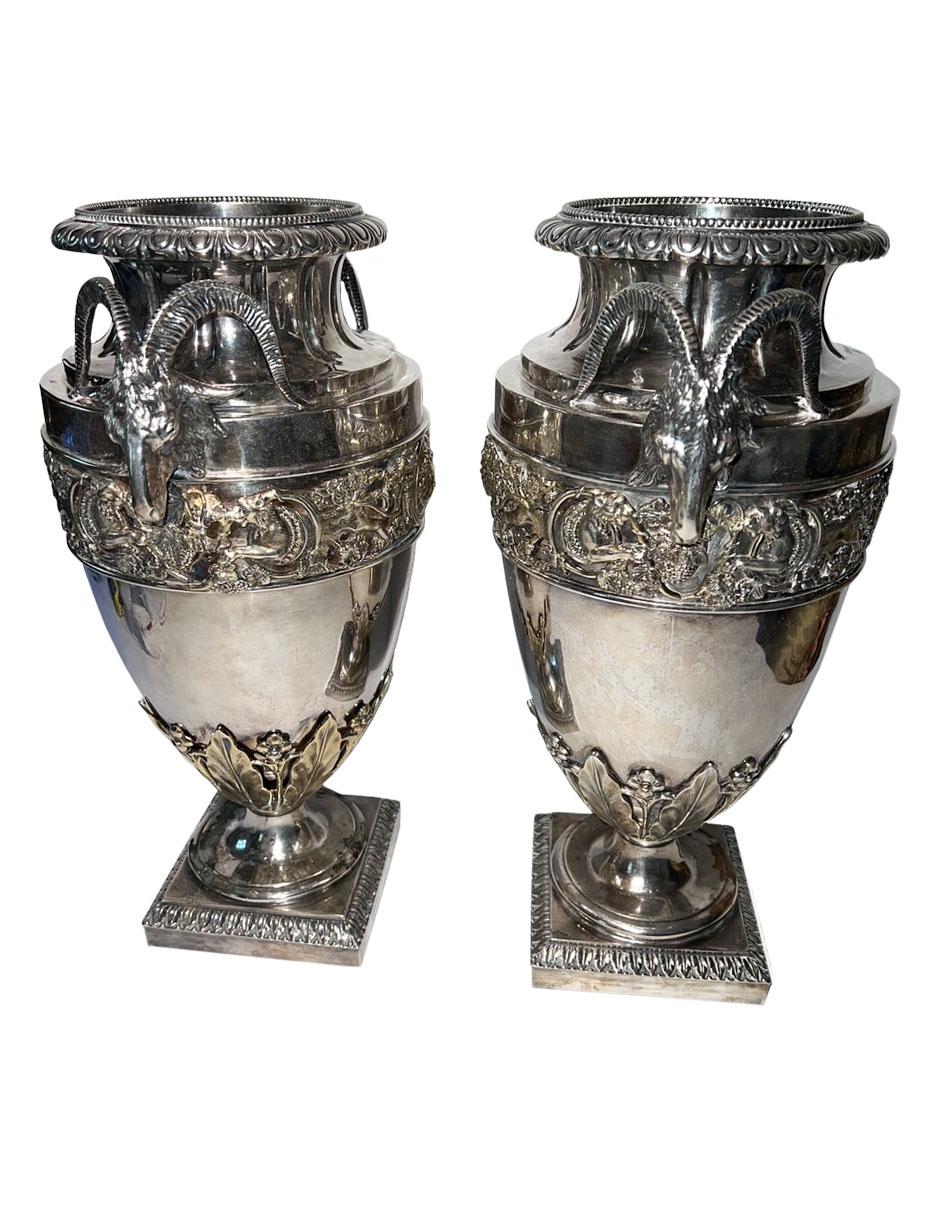 A pair of Sheffield silver plated urns with rams heads and faces. Each urn is etched with a coronet (crown ) to the body. Some silver missing off of the bases. English  circa 1850.