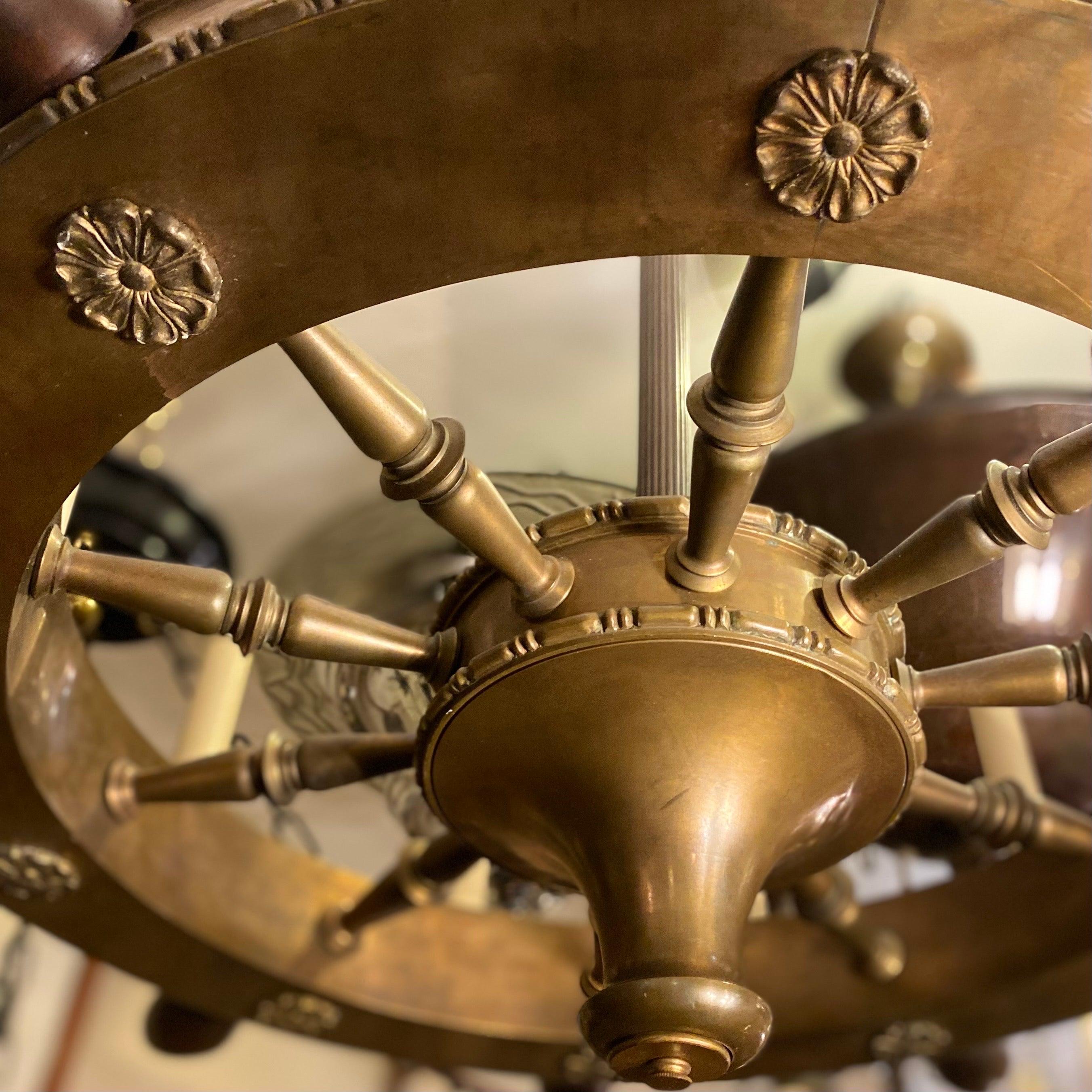 A circa 1940s English cast bronze and wood ship's wheel chandelier with 10 lights.

Measurements:
Diameter 30