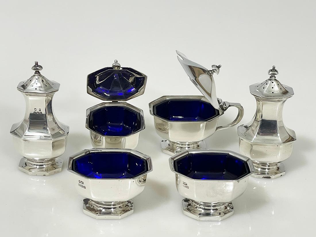 English Silver condiment set by Mappin & Webb, Birmingham, 1927

A silver set with blue glass liners in the salt cellars and mustard pots
The set consists of two pepper shakers, two salt cellars and two lidded mustard pots
The set is made by Mappin