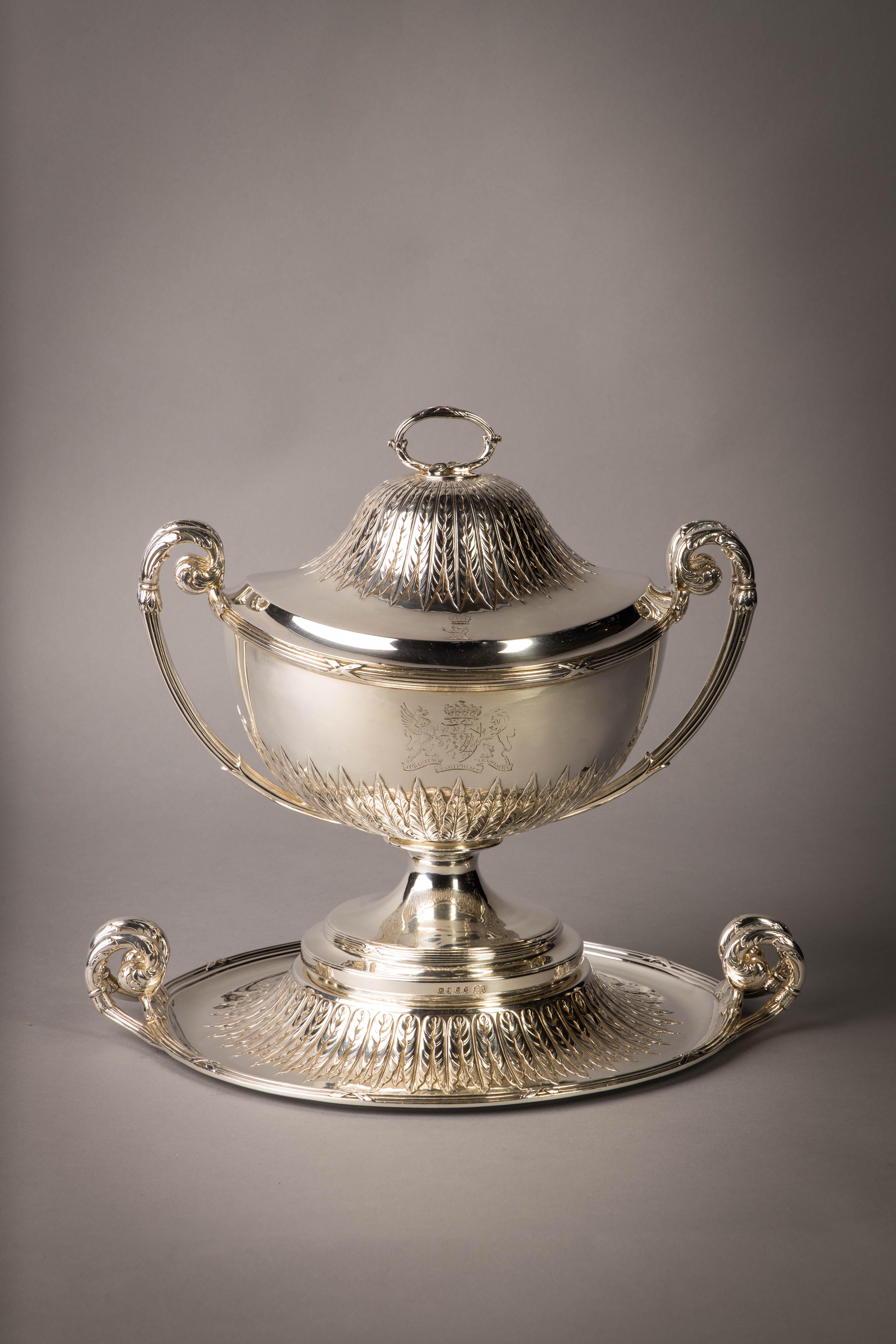 A George III silver soup tureen on stand from the Camden service. Marked: London, 1794/1795. Maker: Paul Storr. On circular stand chased with palmette leaves, with tied reeded borders and two leaf-capped bifurcated handles, the circular bowl with