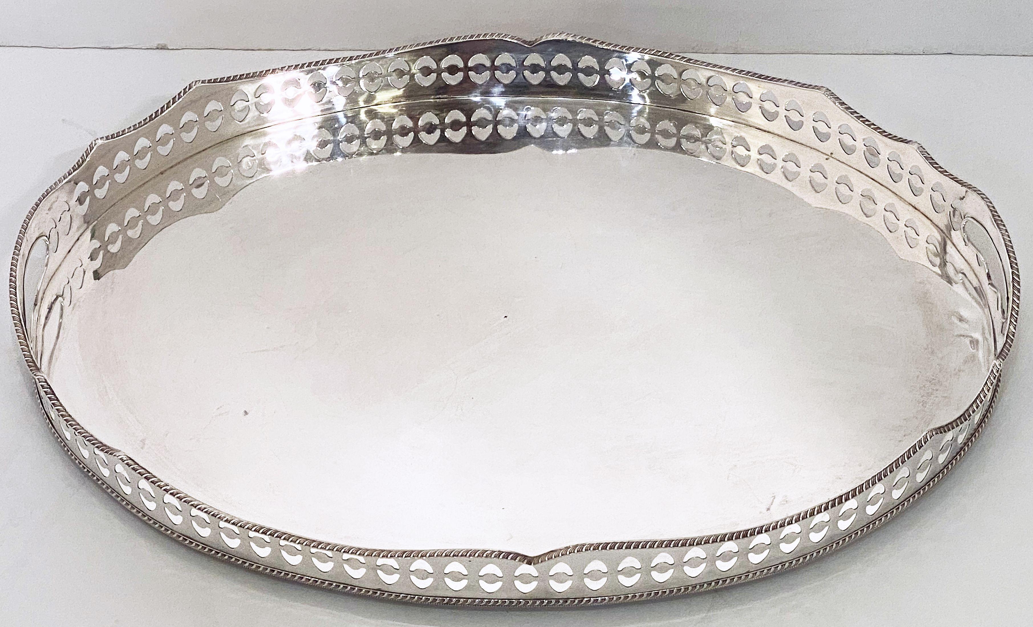 A handsome large English oval gallery serving or drinks tray (or platter) of fine plate silver - featuring a pierced serpentine gallery with a distinctive design around the circumference.

Dimensions: Gallery H 2 1/4 inches x W 20 1/2 inches x D