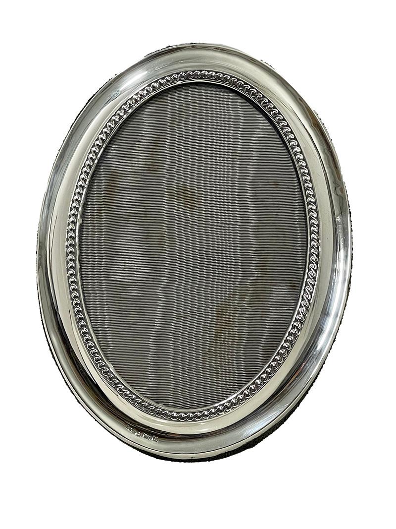 English silver picture frame attributed to Henry Matthews, 1922

A silver oval picture frame made in England, probably made by Henry Matthews (Hall mark is a bit faded) Dated with the English hallmark X for the Year 1922. The silver hall mark of the