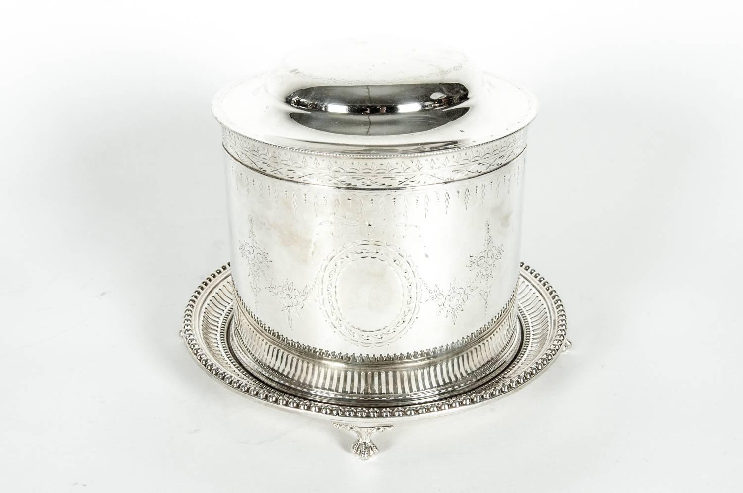 Beautiful English silver plate covered biscuit box/tea caddy with attached footed gallery tray. The Caddy is in excellent condition, it measures 10 inches high with lid open X 8 inches diameter. Maker's mark undersigned.