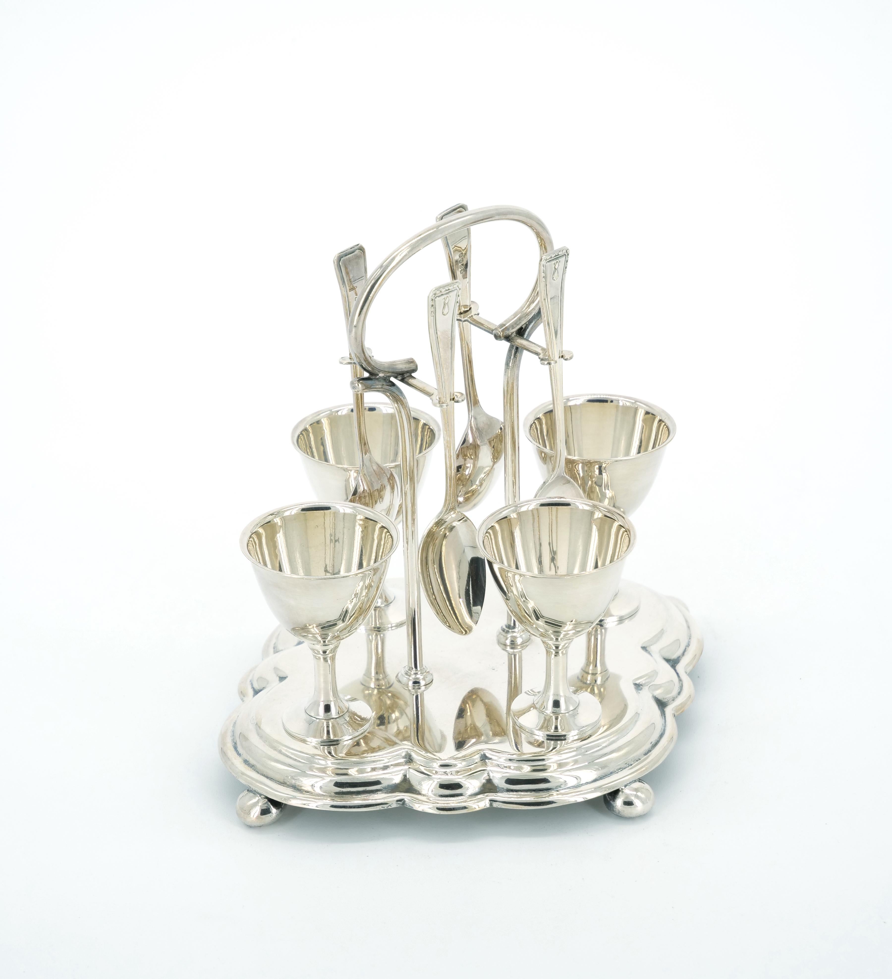 Transport yourself to the elegance of the 19th century with our English Silver-Plated Breakfast Tableware – a charming set of four soft-boiled egg holders accompanied by four dainty spoons. This exquisite service is a testament to the timeless