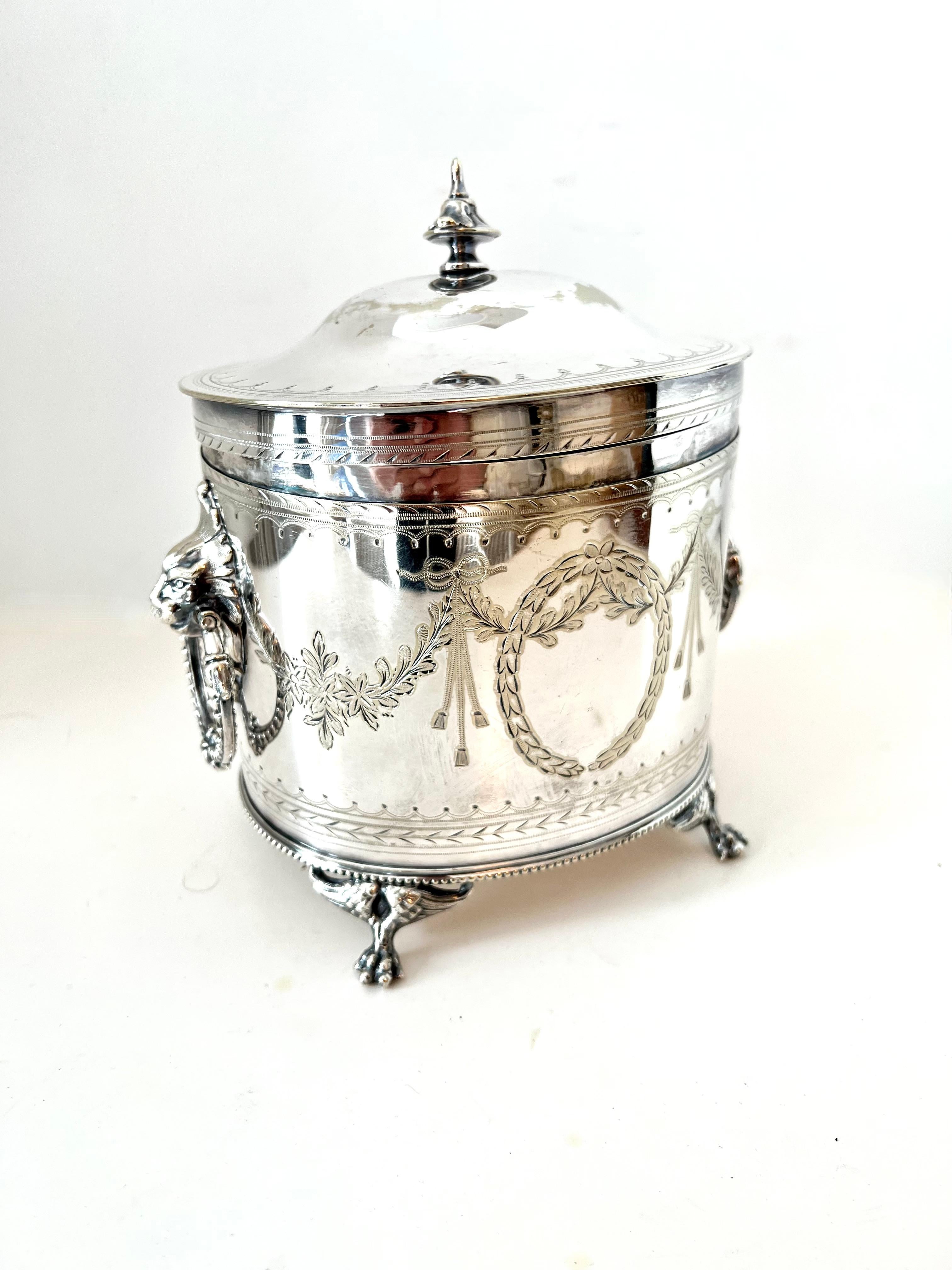 A beautifully designed Silver Plate Tea Caddy with Hinged Lid.

The piece is a compliment to any Tea station, counter, or also works well on a desk or work station, to hold everything from Tea to office supplies.

The English design with Garlands