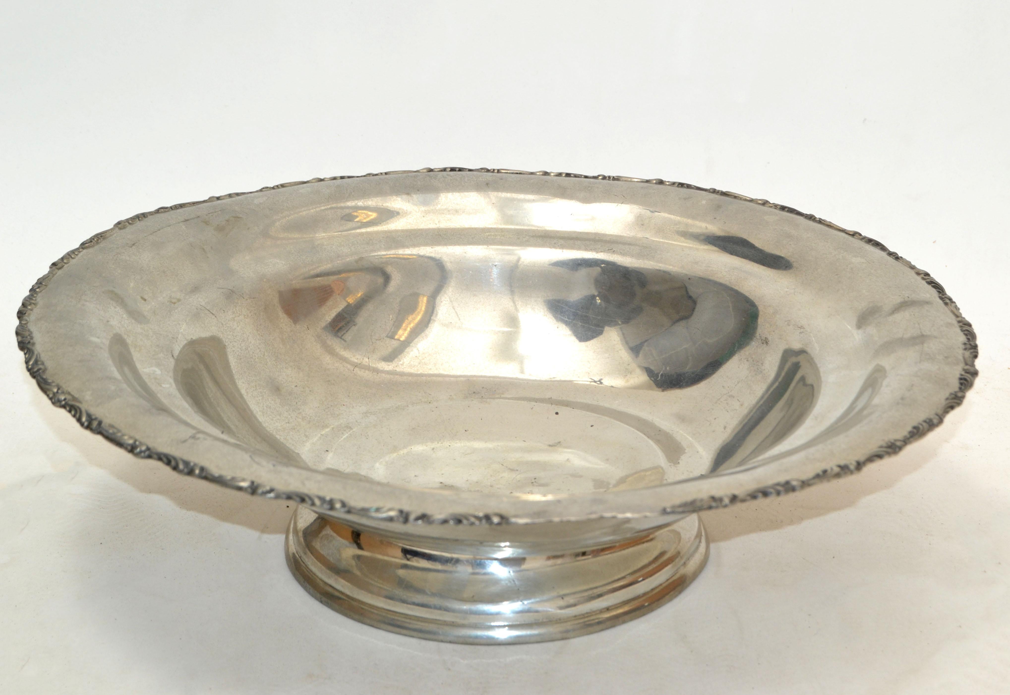 Vintage English silver round serving bowl with ornate flowers on pedestal.
It is in original vintage condition and has some stains and is tarnished.
Marked: English Silver MFG Corp. Quadrupled Silver Plate numbered 332 & Trademark at the