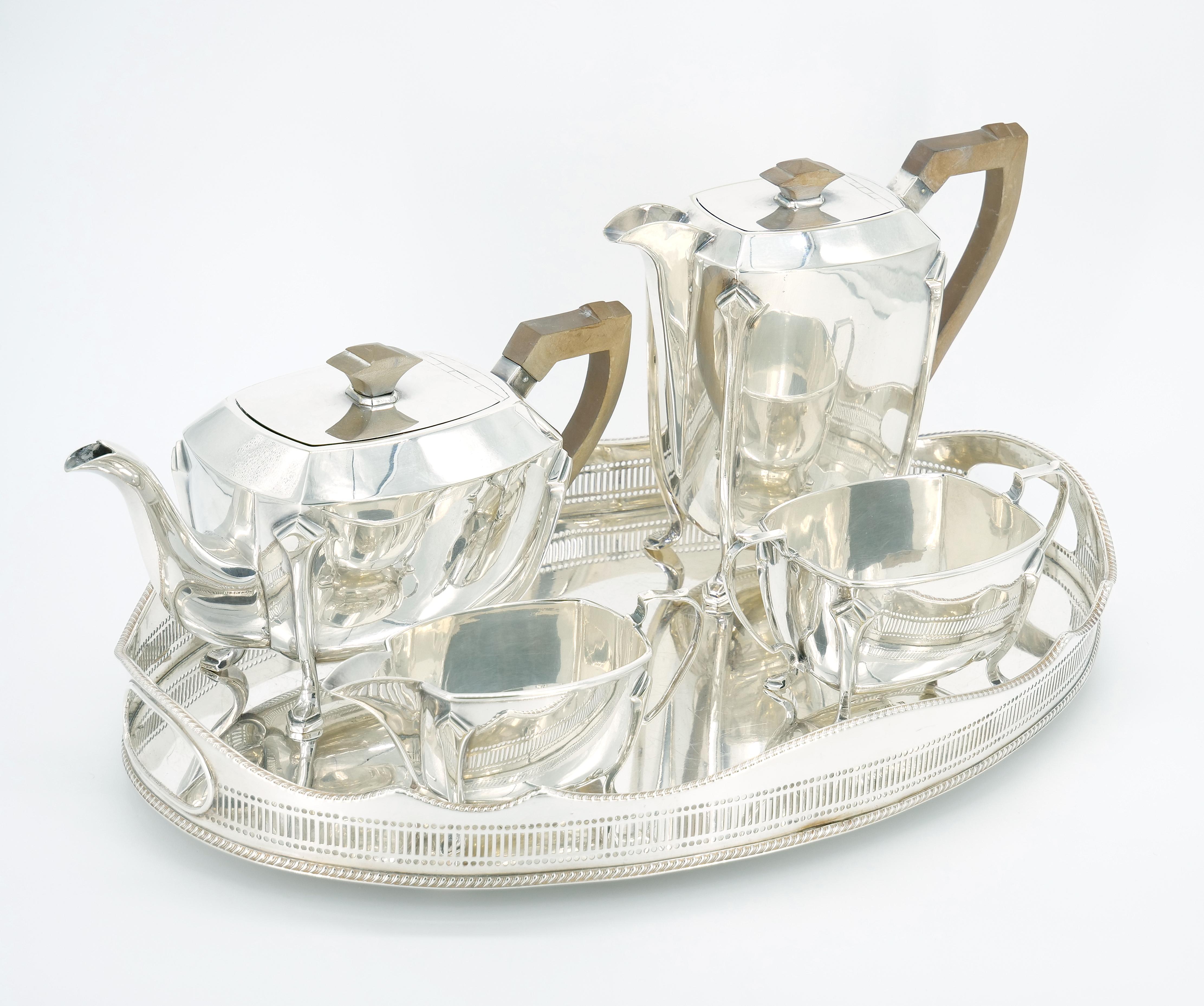 Transport yourself to the elegance of the Early 20th Century with our English Silver-Plated Bone Handle Four-Piece Tea and Coffee Service, accompanied by a sophisticated serving tray. This exquisite set seamlessly combines Art Deco style with clean
