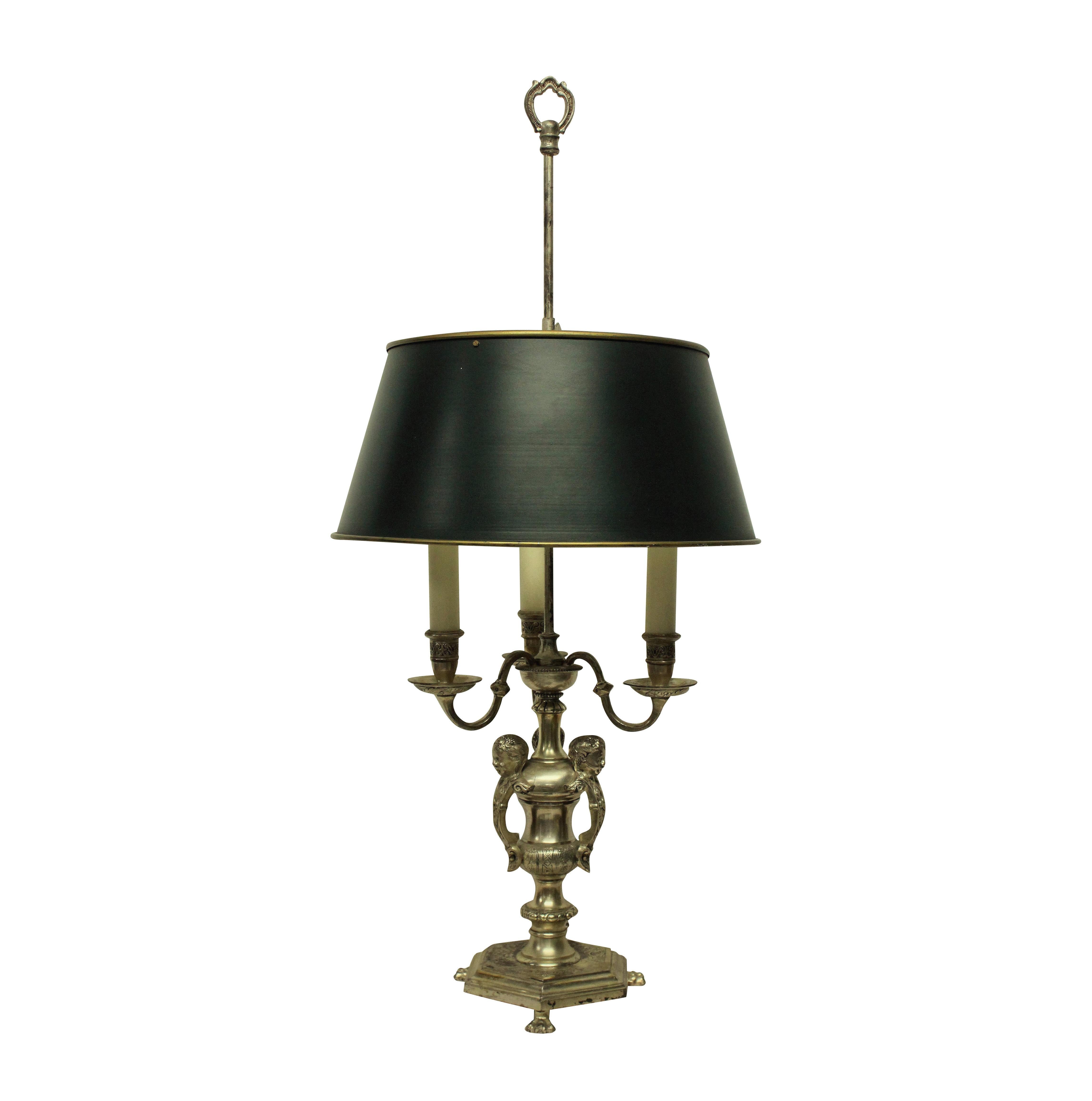 An English silver plated bronze Bouillotte lamp of good quality after Knole.

With three lights and an adjustable shade in dark green.