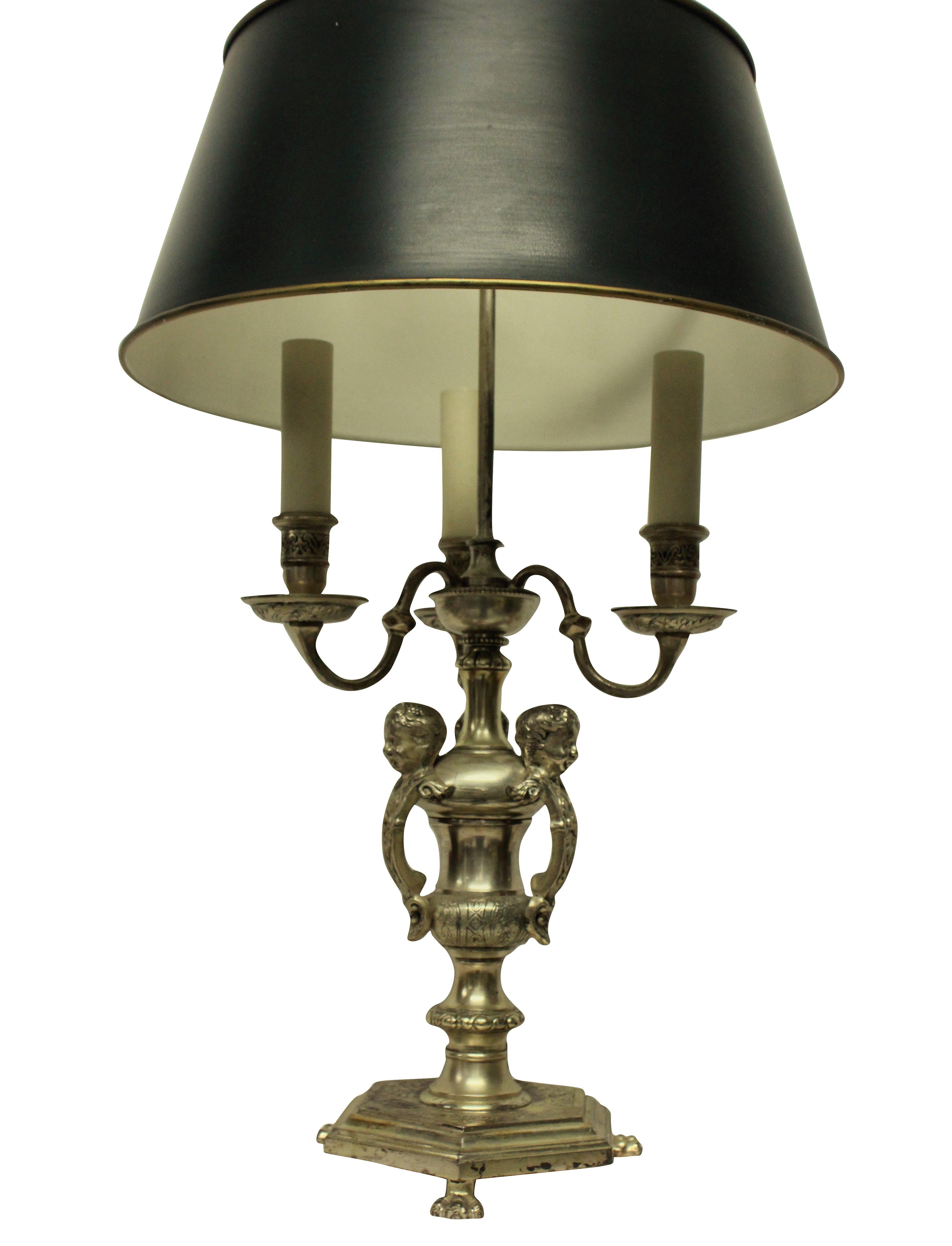 An English silver plated bronze Bouillotte lamp of good quality after Knole.

With three lights and an adjustable shade in dark green.