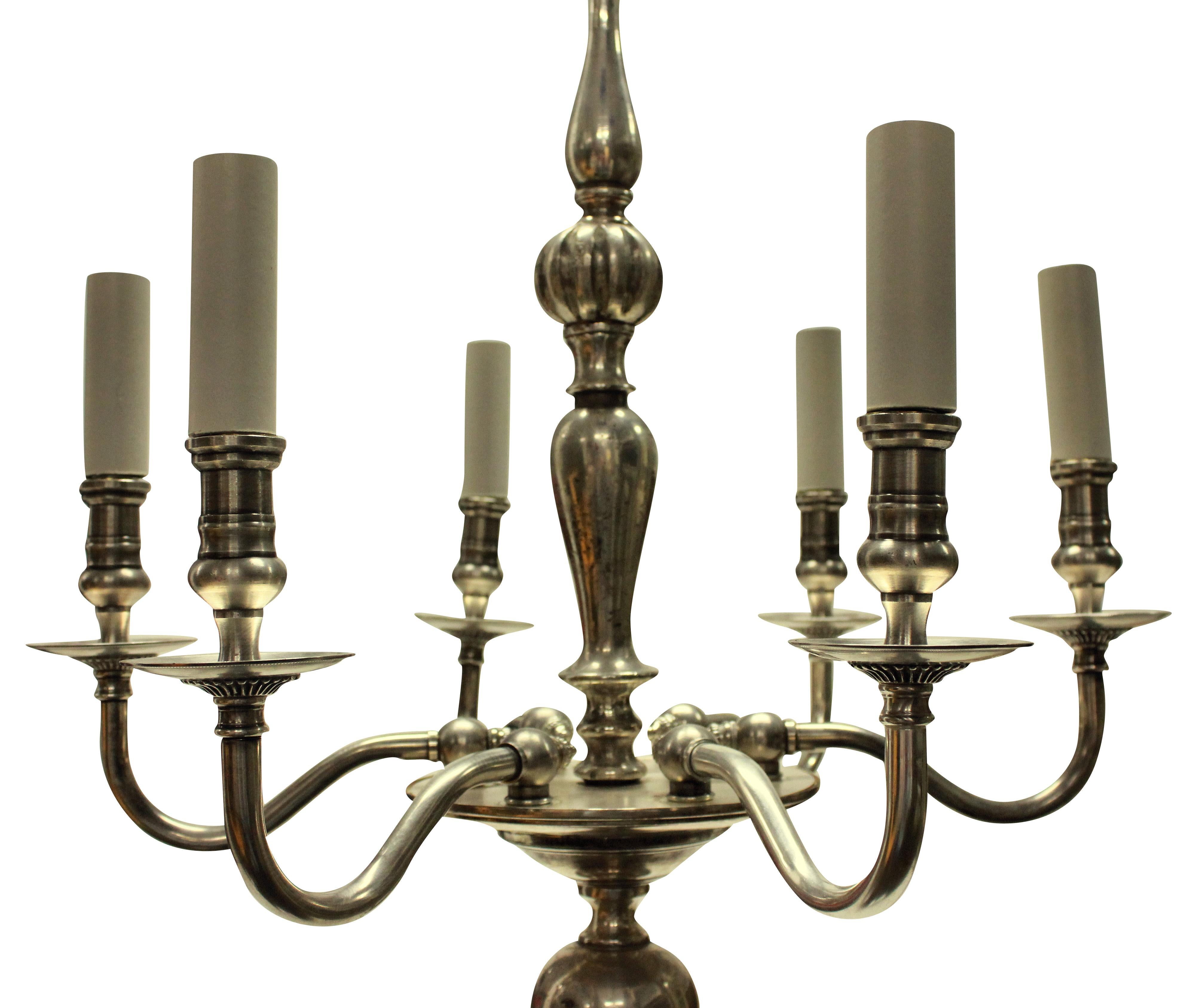 An English, six-arm silver plated chandelier of simple form.