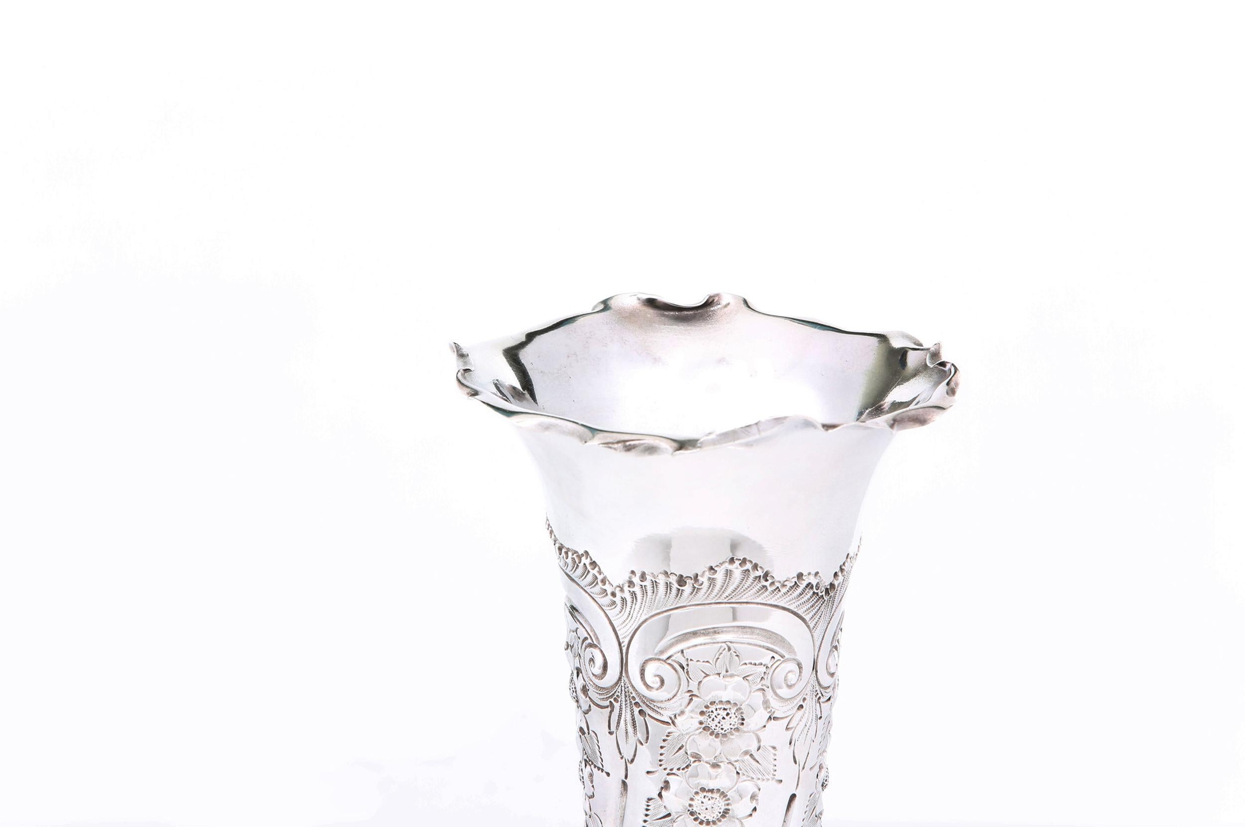 Beautiful English silver plated decorative vase with exterior floral design details. The vase is in great condition. Maker's mark undersigned. The vase stand about 11.5 inches tall x 5 inches diameter.