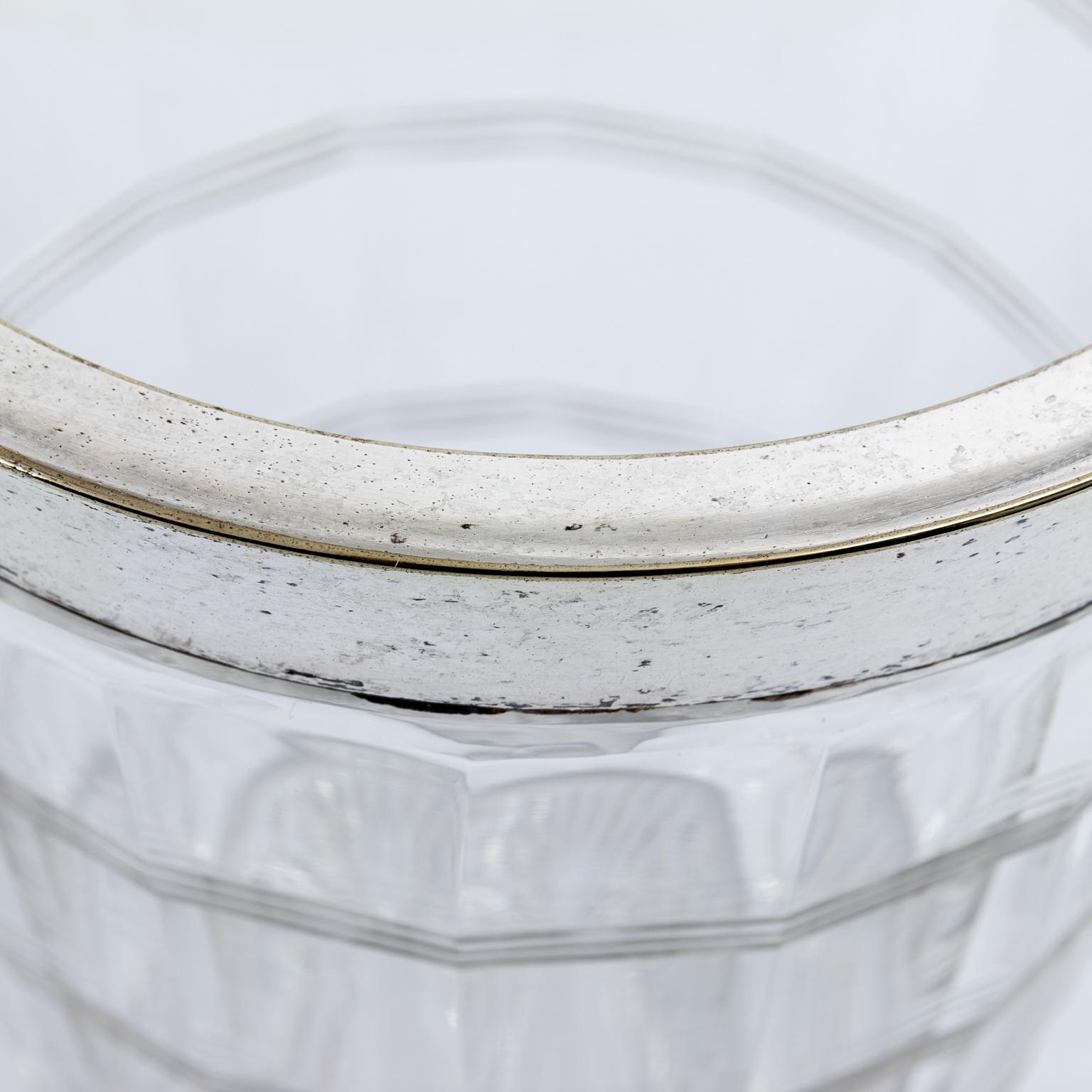 English glass ice pail with silver plated rim and handle, circa 1930s. The body of the pail also features ring detail. Please note of wear consistent with age including minor pitting to the metal rim. Made in England.